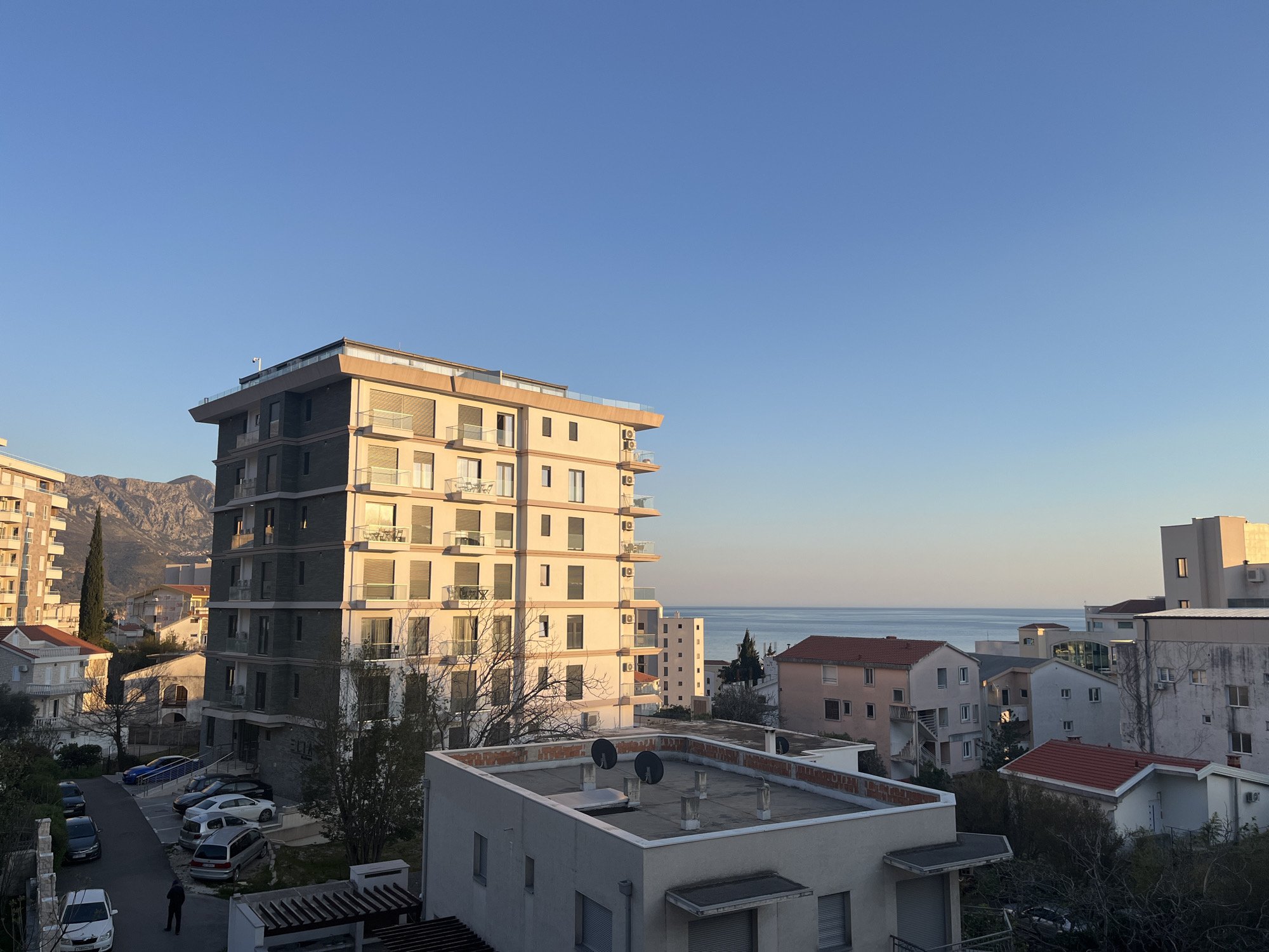 Woman observed at window overlooking Boreti Montenegro residential area