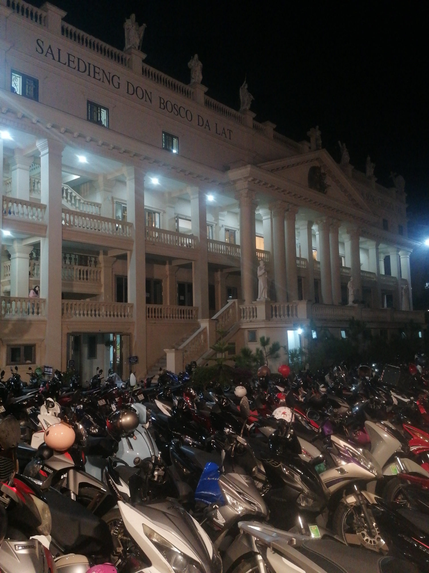 Nighttime Da Lat: colonial buildings, religious statues, quiet streets