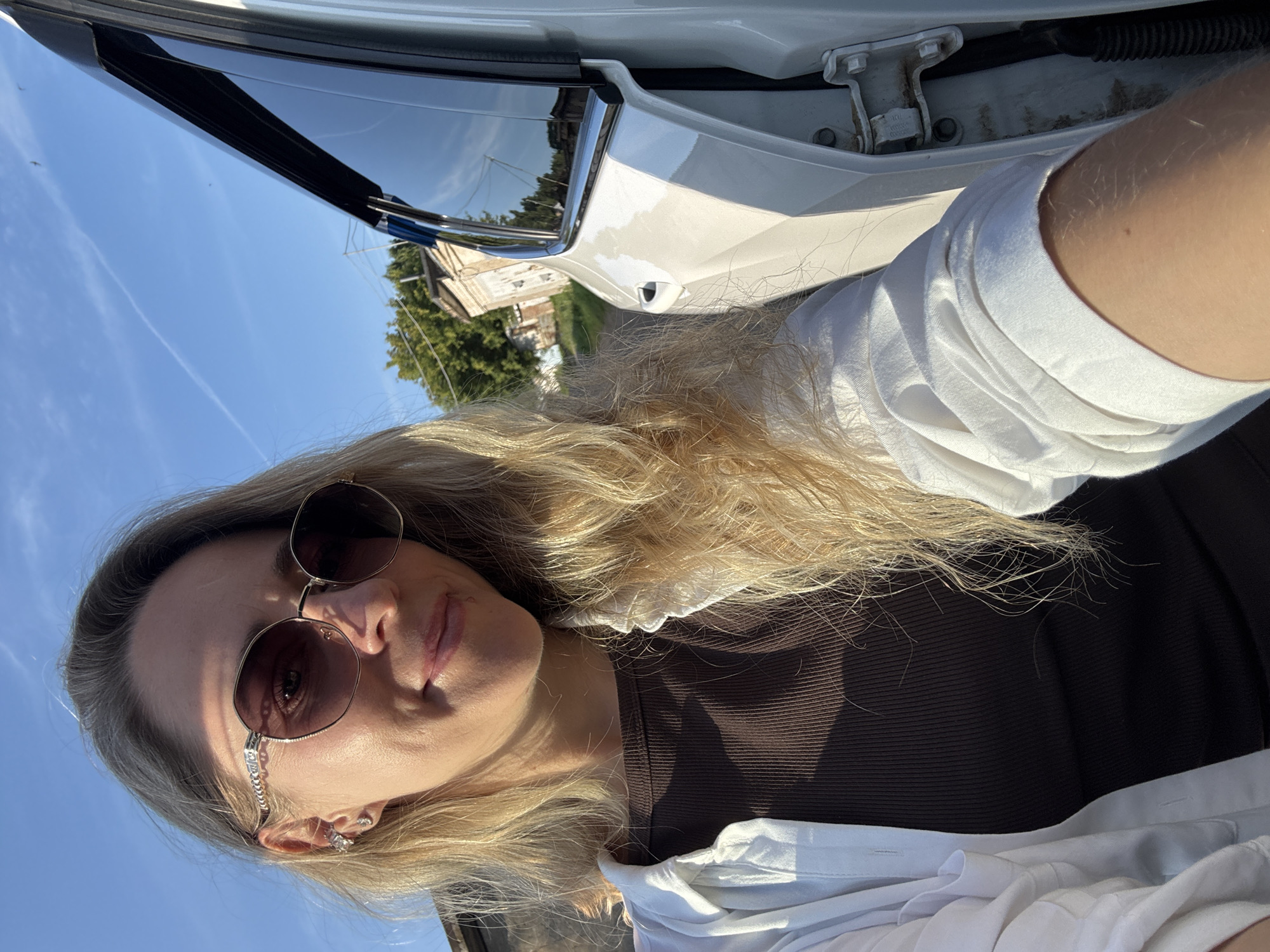 Selfie in Chaikovsky featuring gold-rimmed sunglasses and summer style
