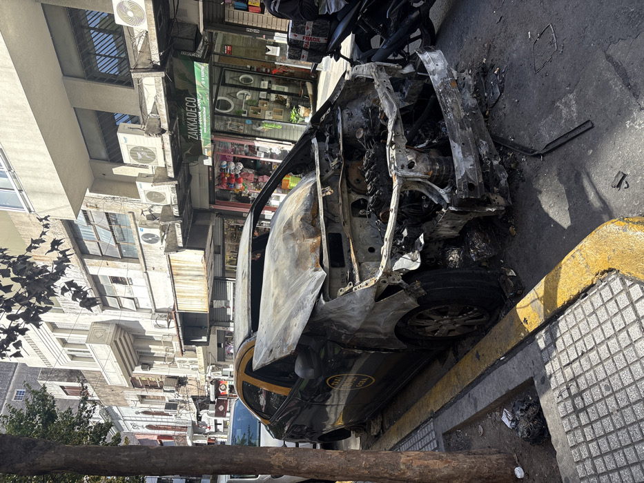 Fire-damaged taxi and street scenes documented in Buenos Aires