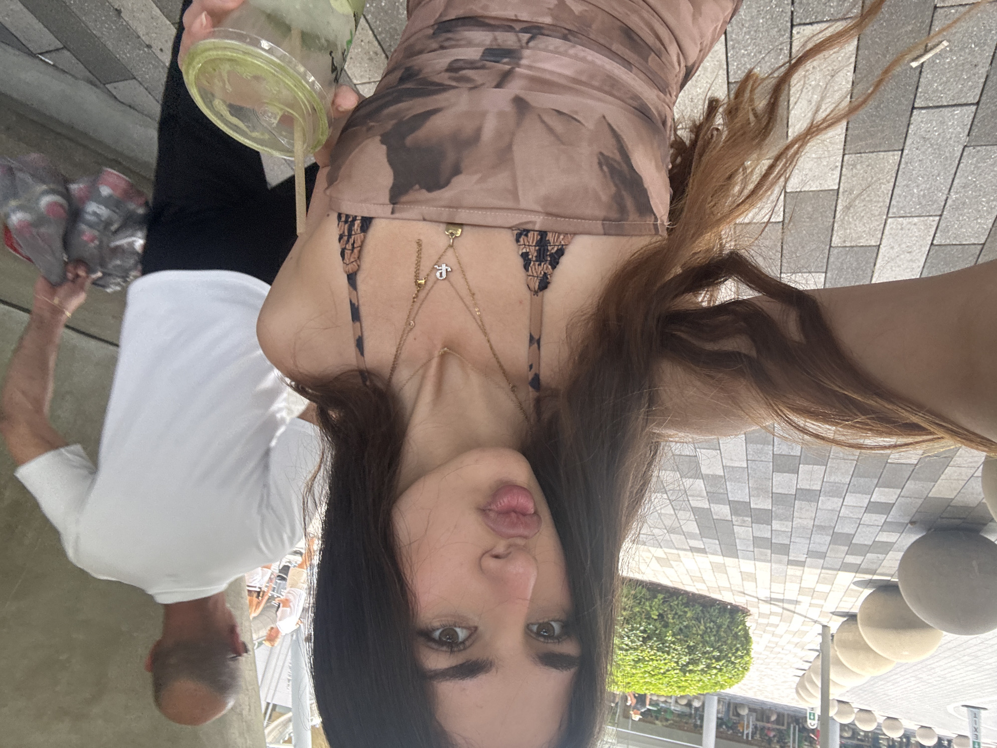 Woman takes selfie near decorative animal fountain in Aventura