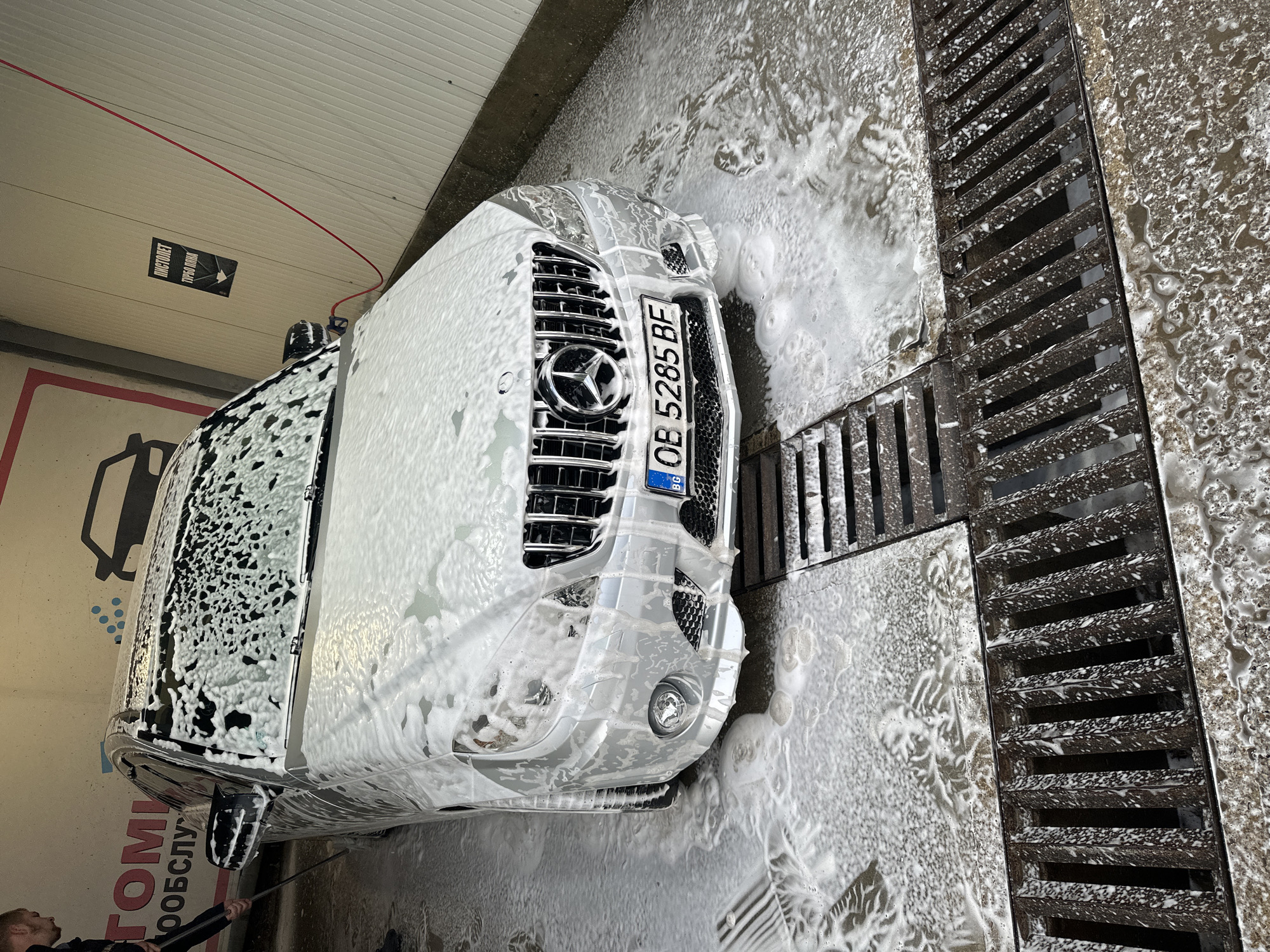 Silver Mercedes gets washed at car wash facility