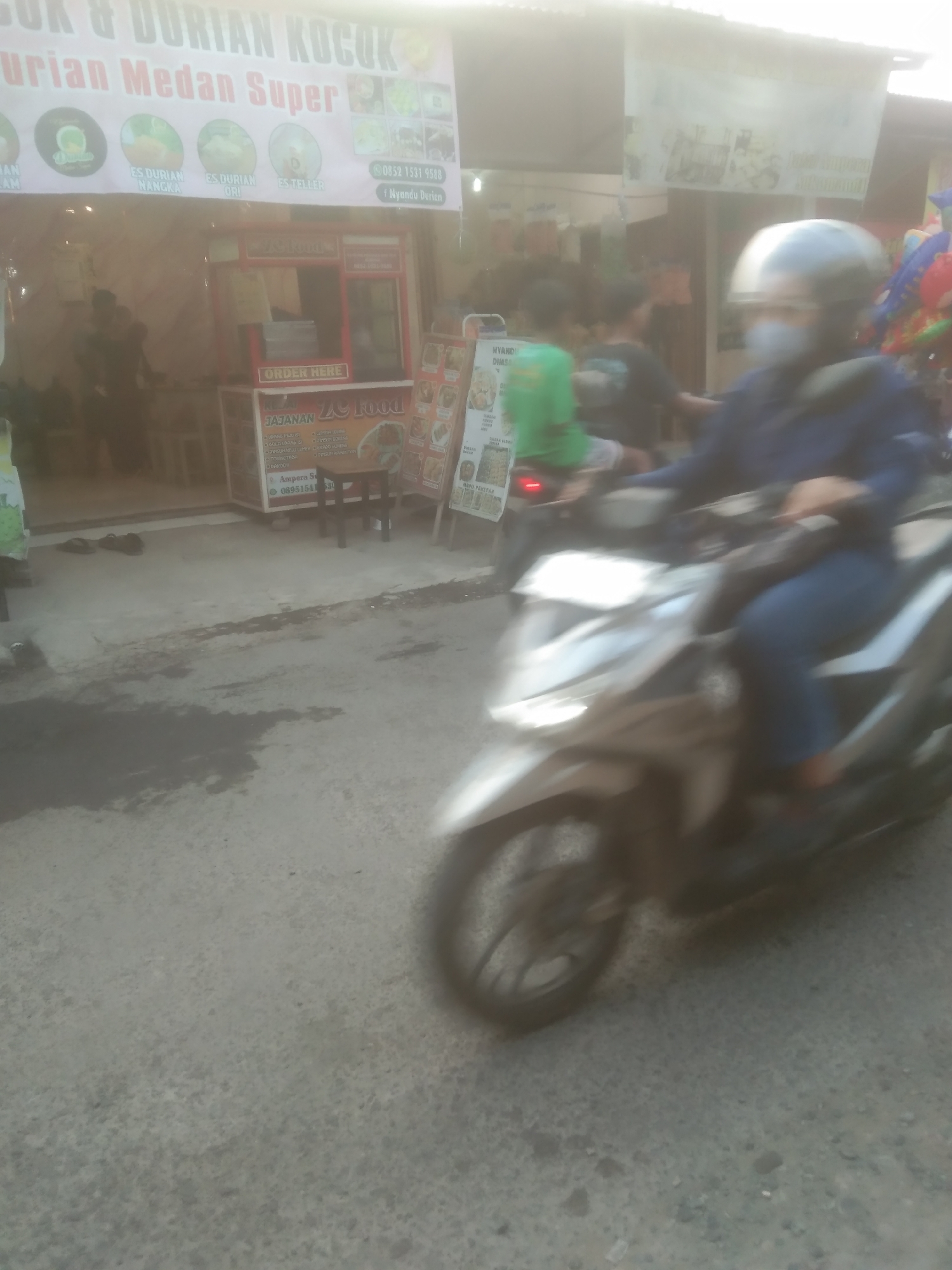 Morning street life along a commercial strip in Subang, Indonesia