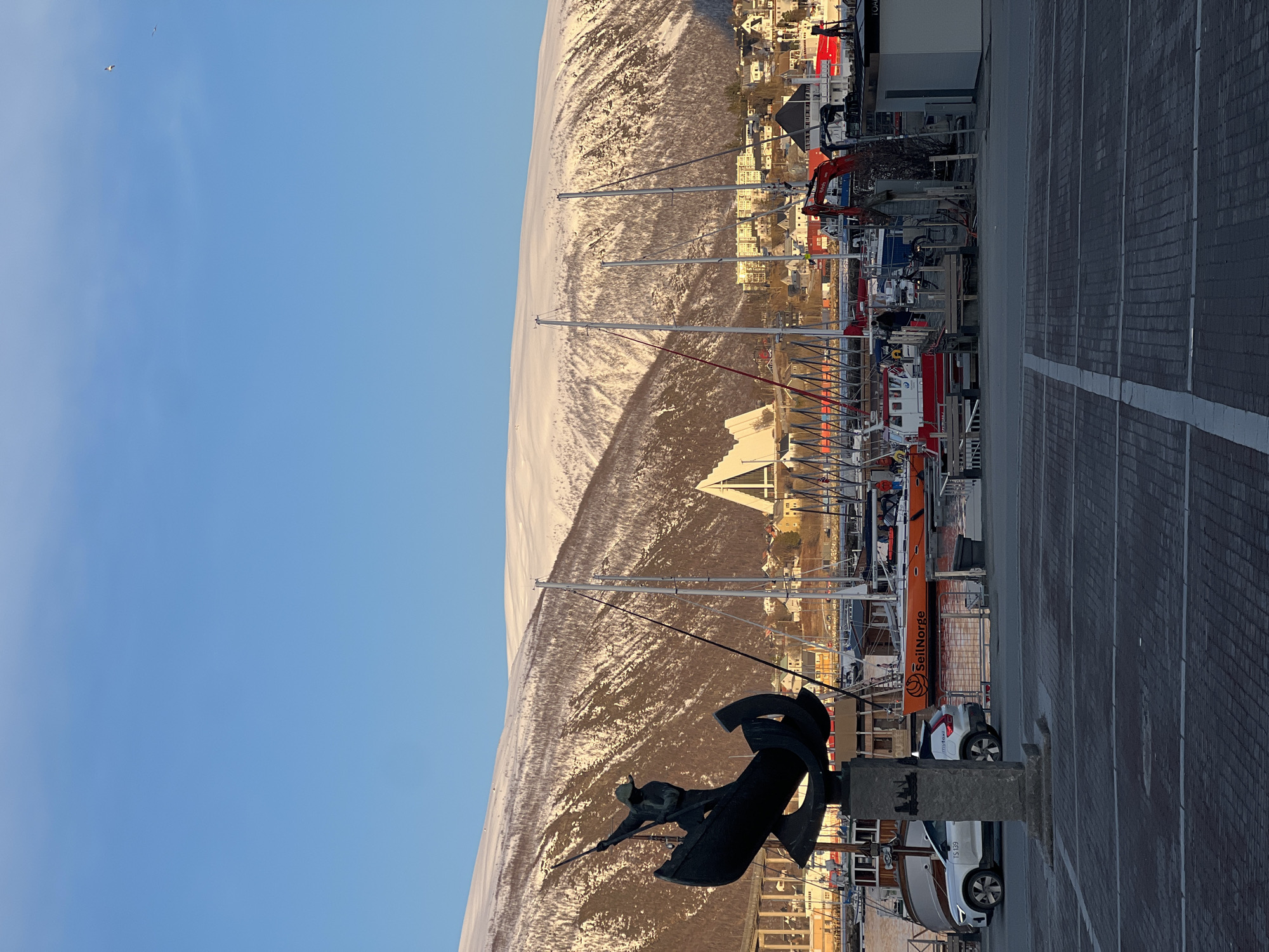 Maritime statue photographed at Tromsø harbor with snowy backdrop