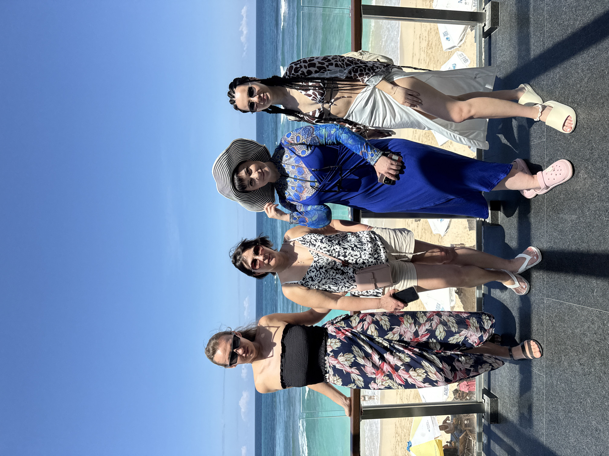 Four women pose for beach photo in Kuta Selatan