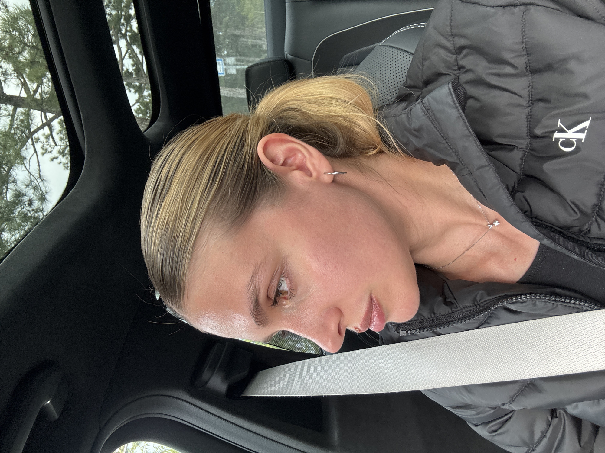 Woman with ponytail sits in vehicle in Tbilisi