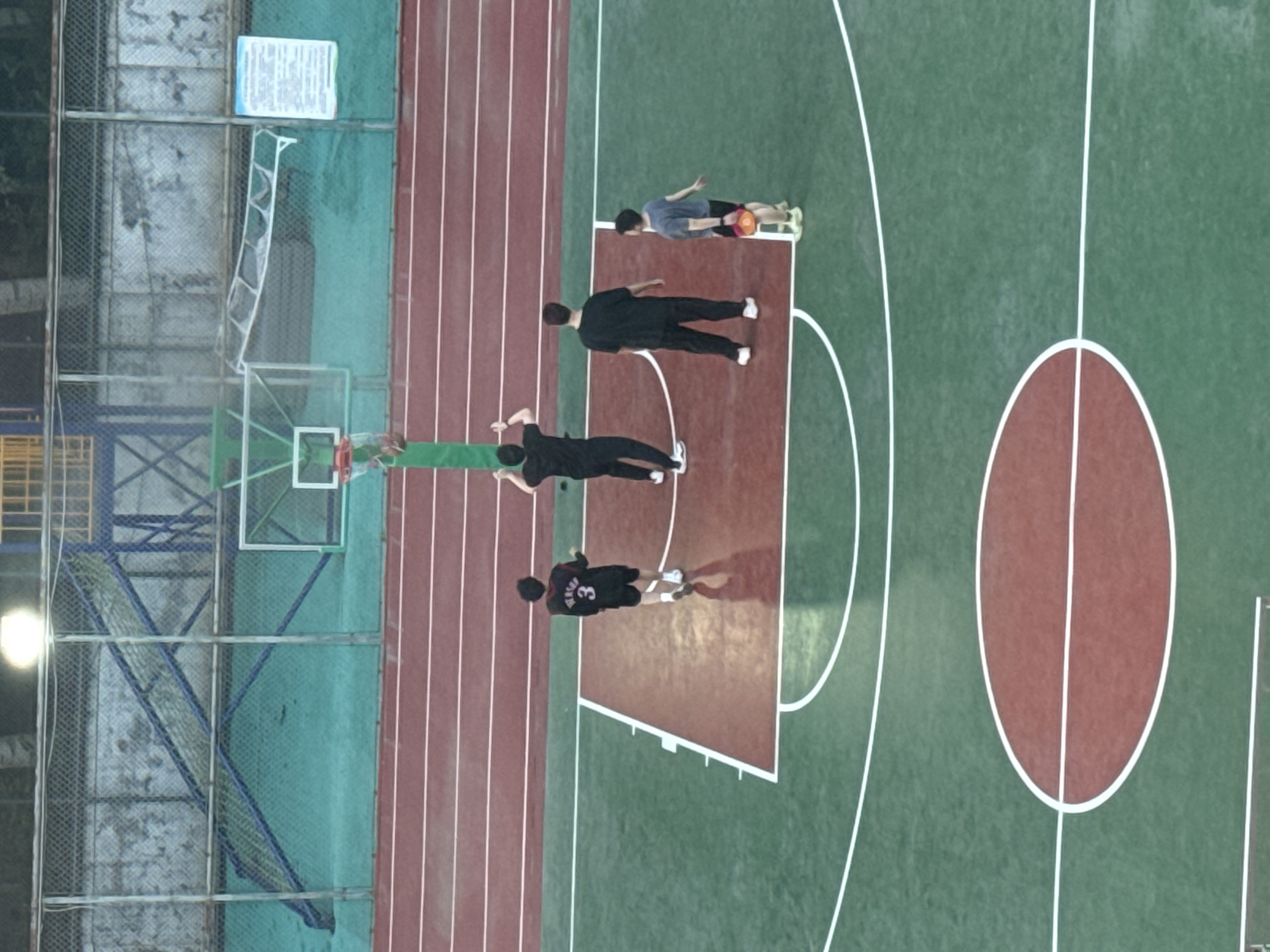People gather on outdoor basketball court in Beijing suburb