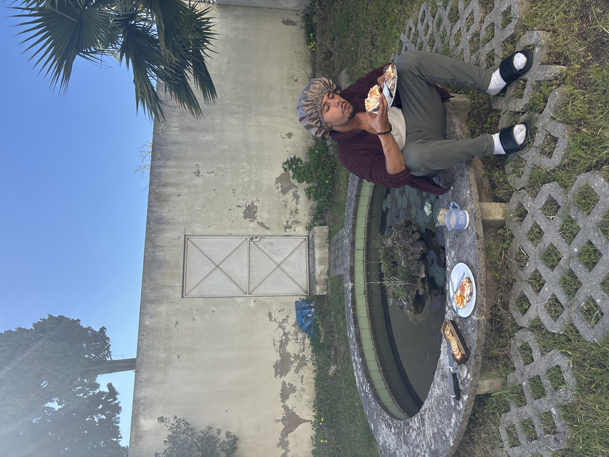 Man eats meal beside water feature in Lisbon