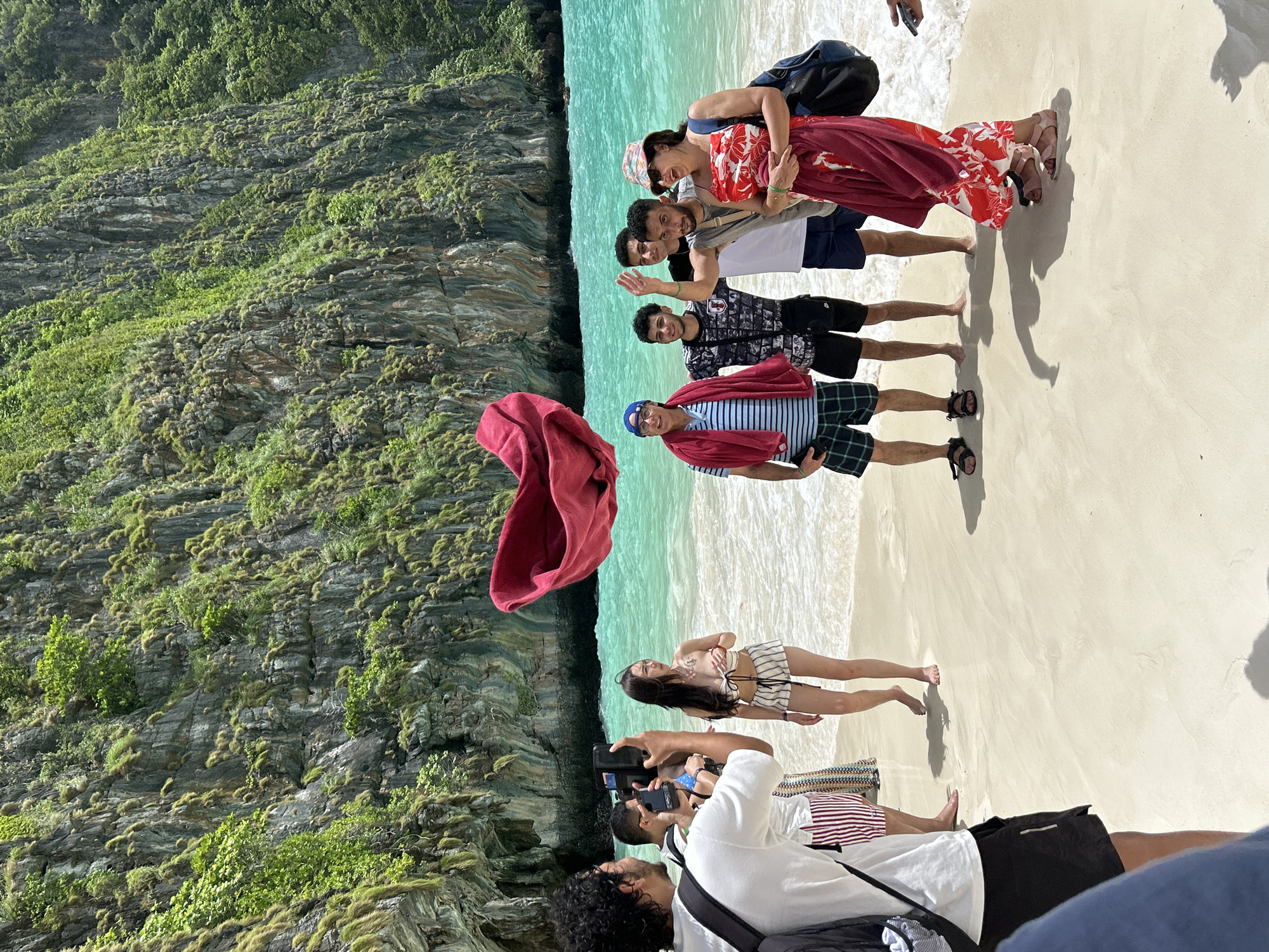 Ao Nang beach busy with visitors beneath limestone cliffs