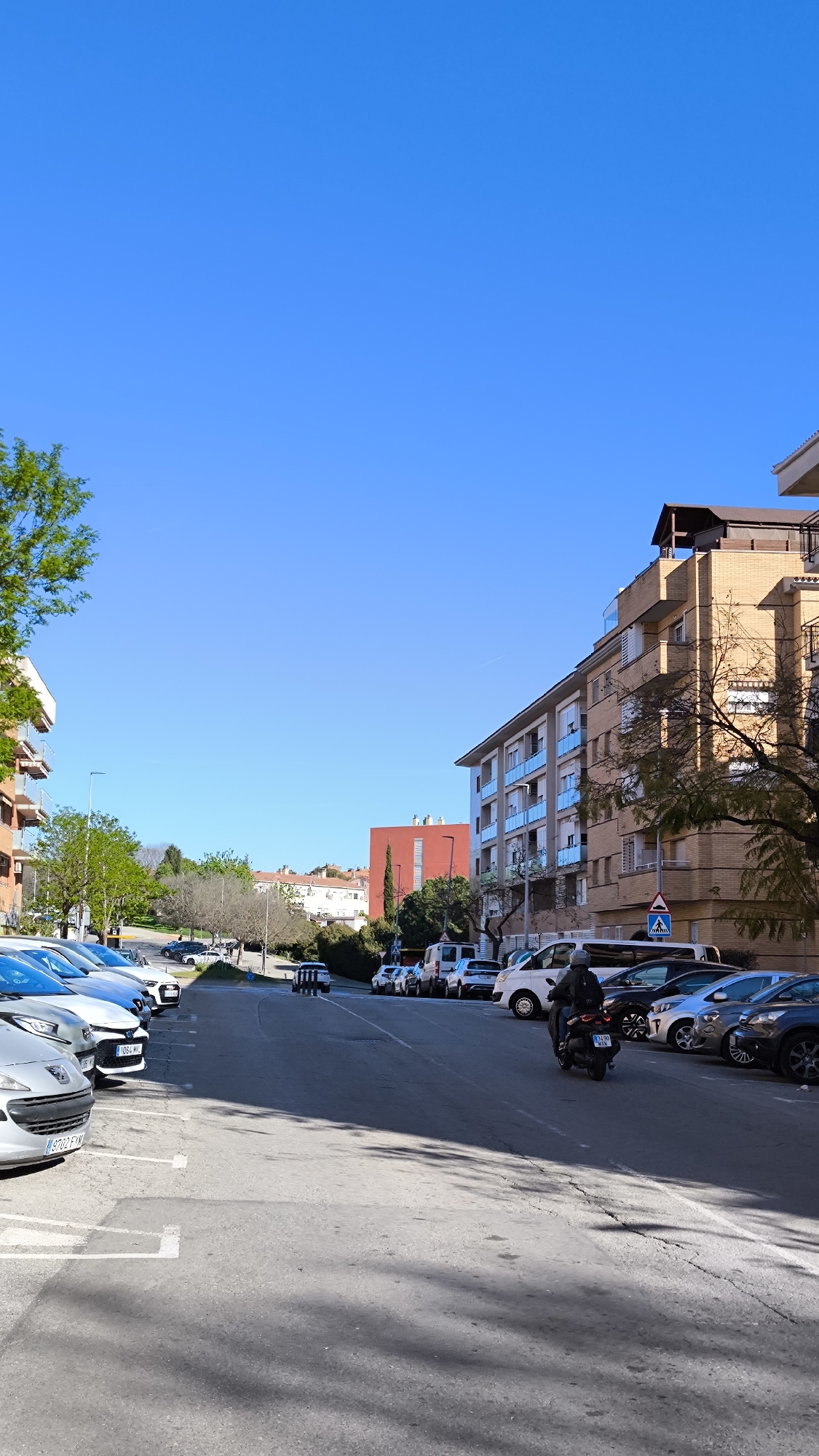Motorcyclist travels residential street in Ripollet, Spain