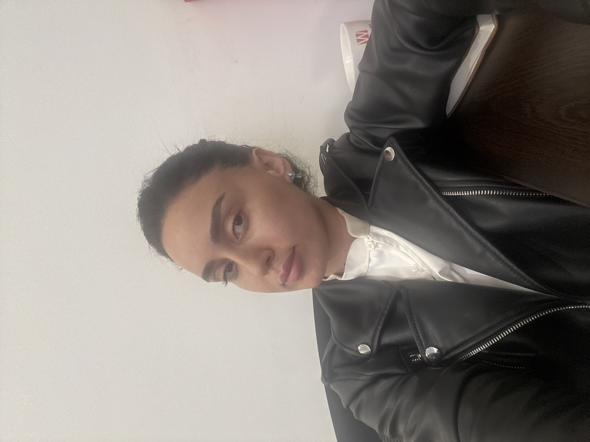 Woman in leather jacket photographed across Tbilisi locations
