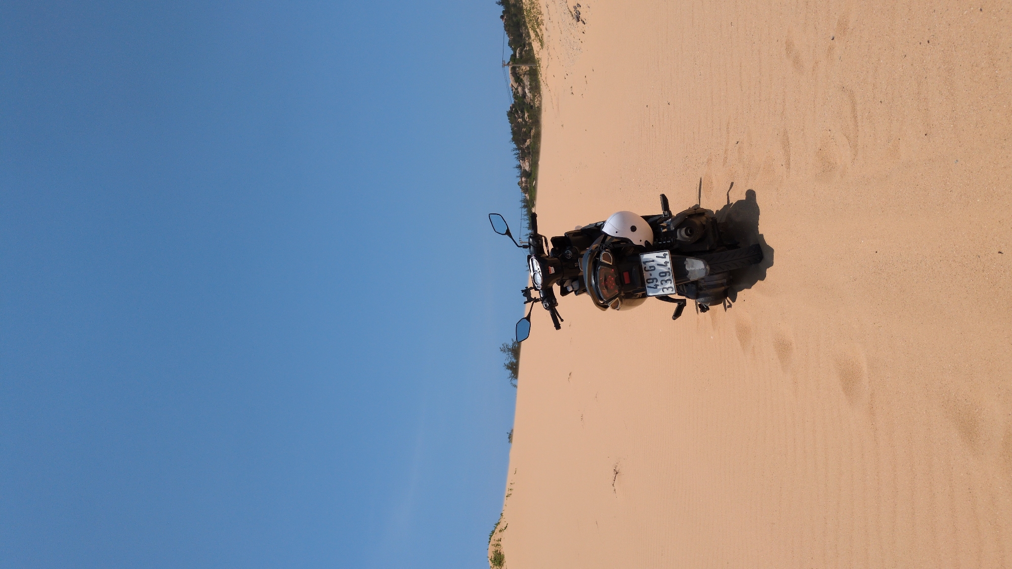 Motorcycle parked on sand dunes near Phuoc Dinh, Vietnam
