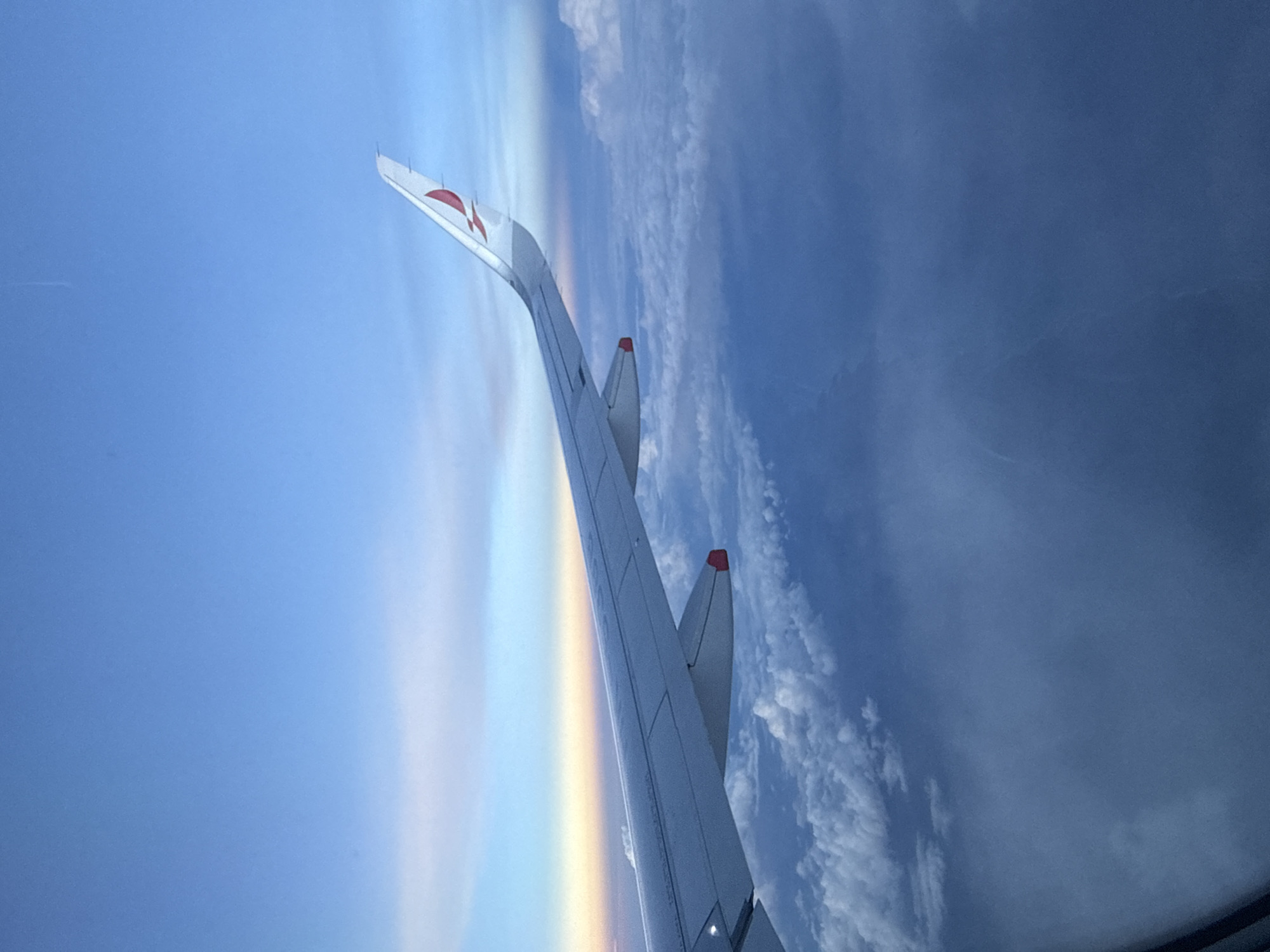 Passenger captures airplane wing view and in-flight entertainment footage