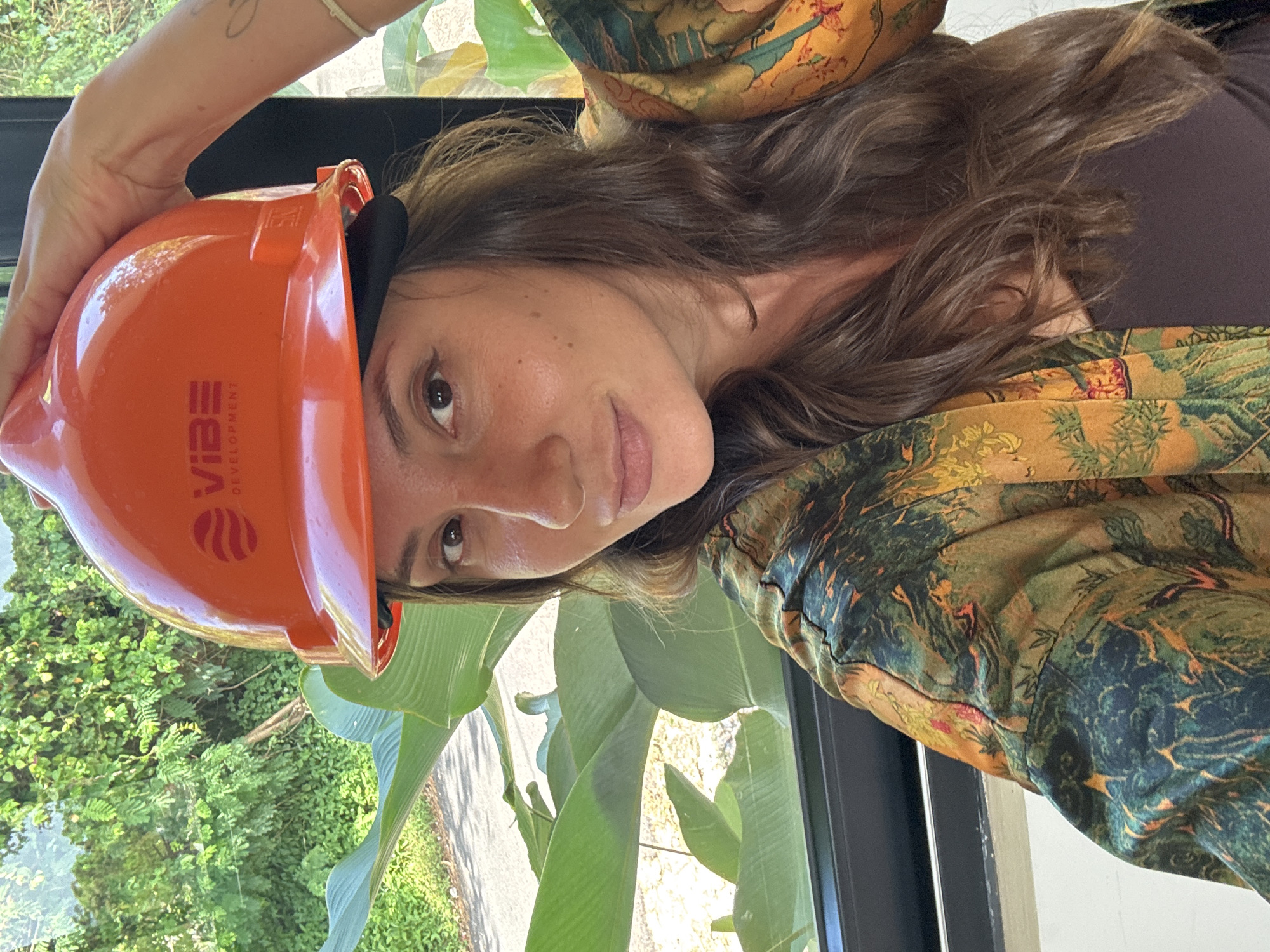 Woman poses with Vibe Development hard hat in Kuta Selatan