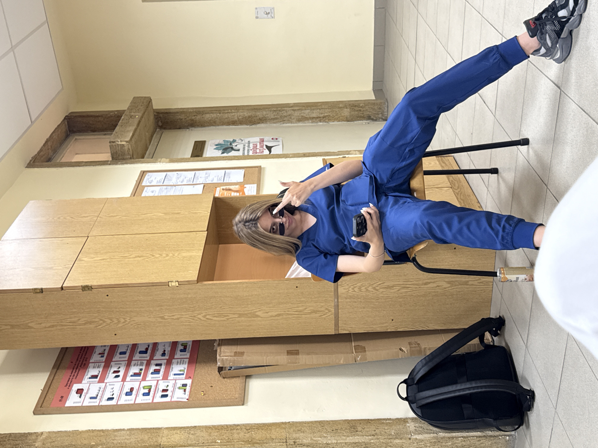 Medical worker in scrubs takes phone break in Pleven