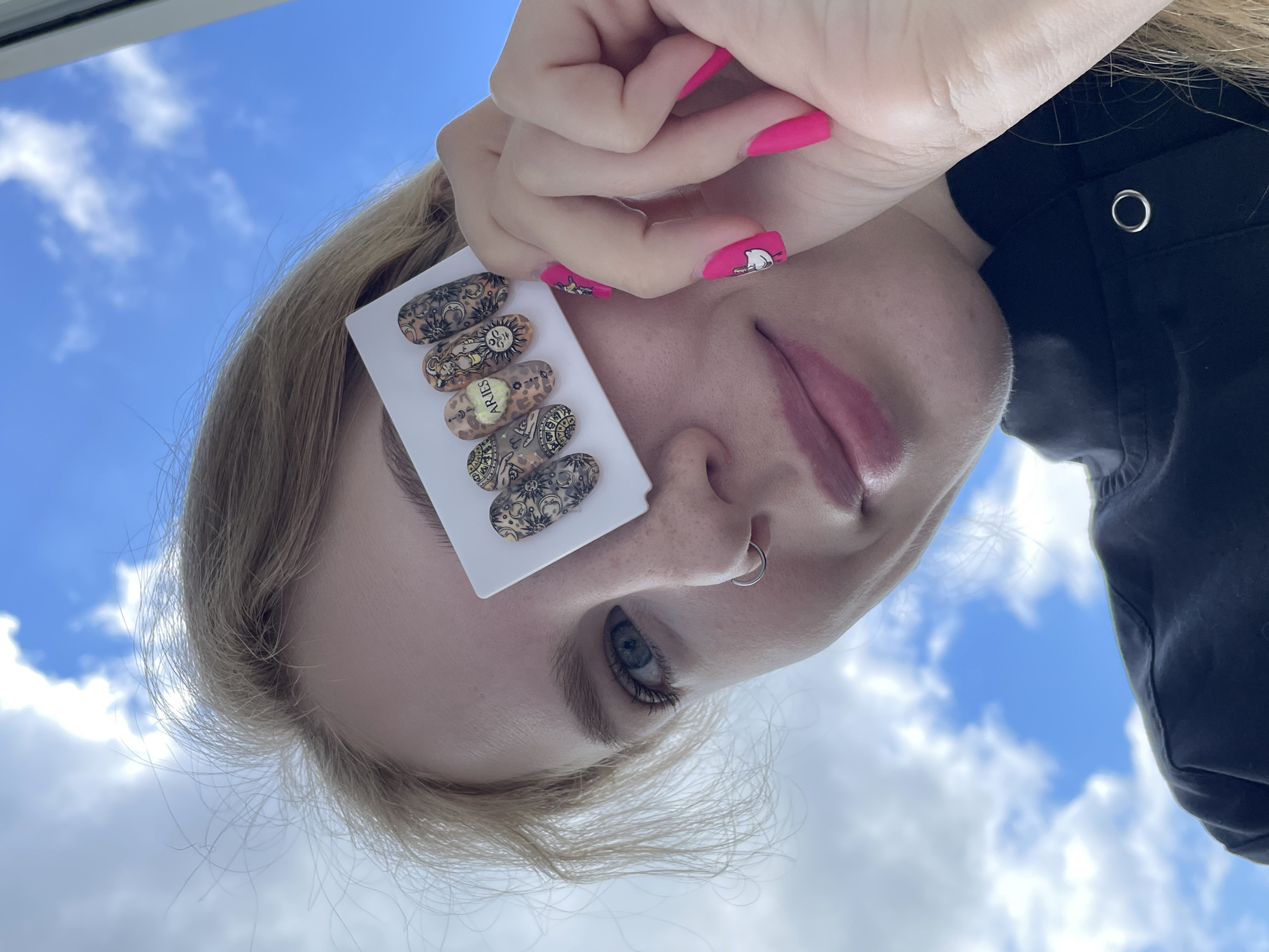 Nail art session documented against blue sky in Izhevsk