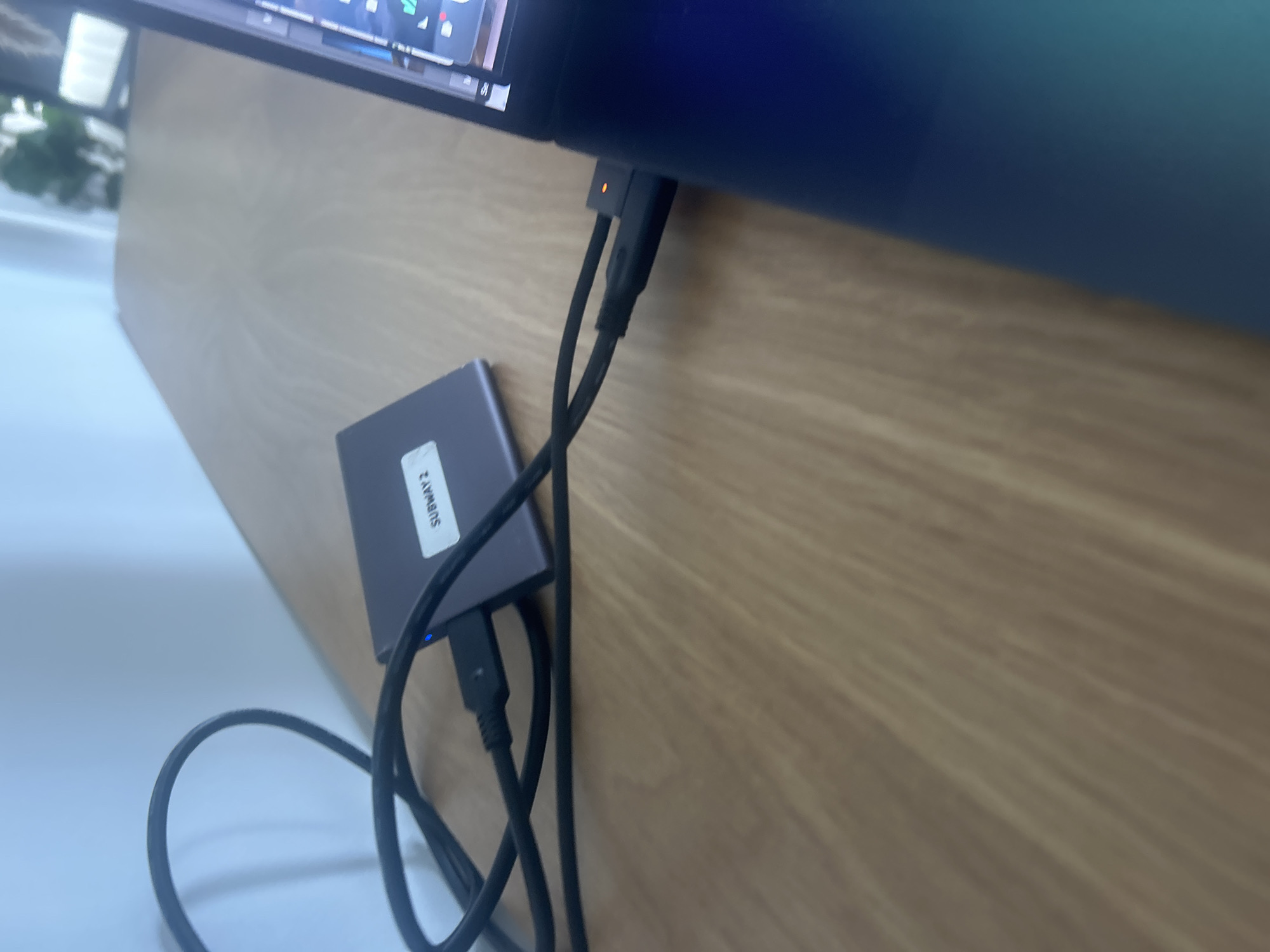Miami computer user connects external hard drive labeled 'SUBWAY 2'