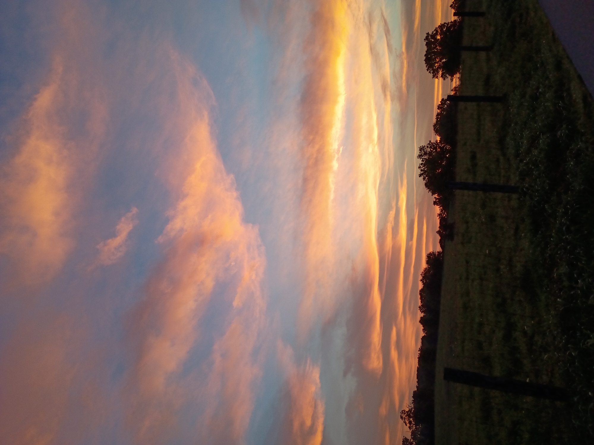 Colorful dusk sky over rural fields near Versailles, Kentucky