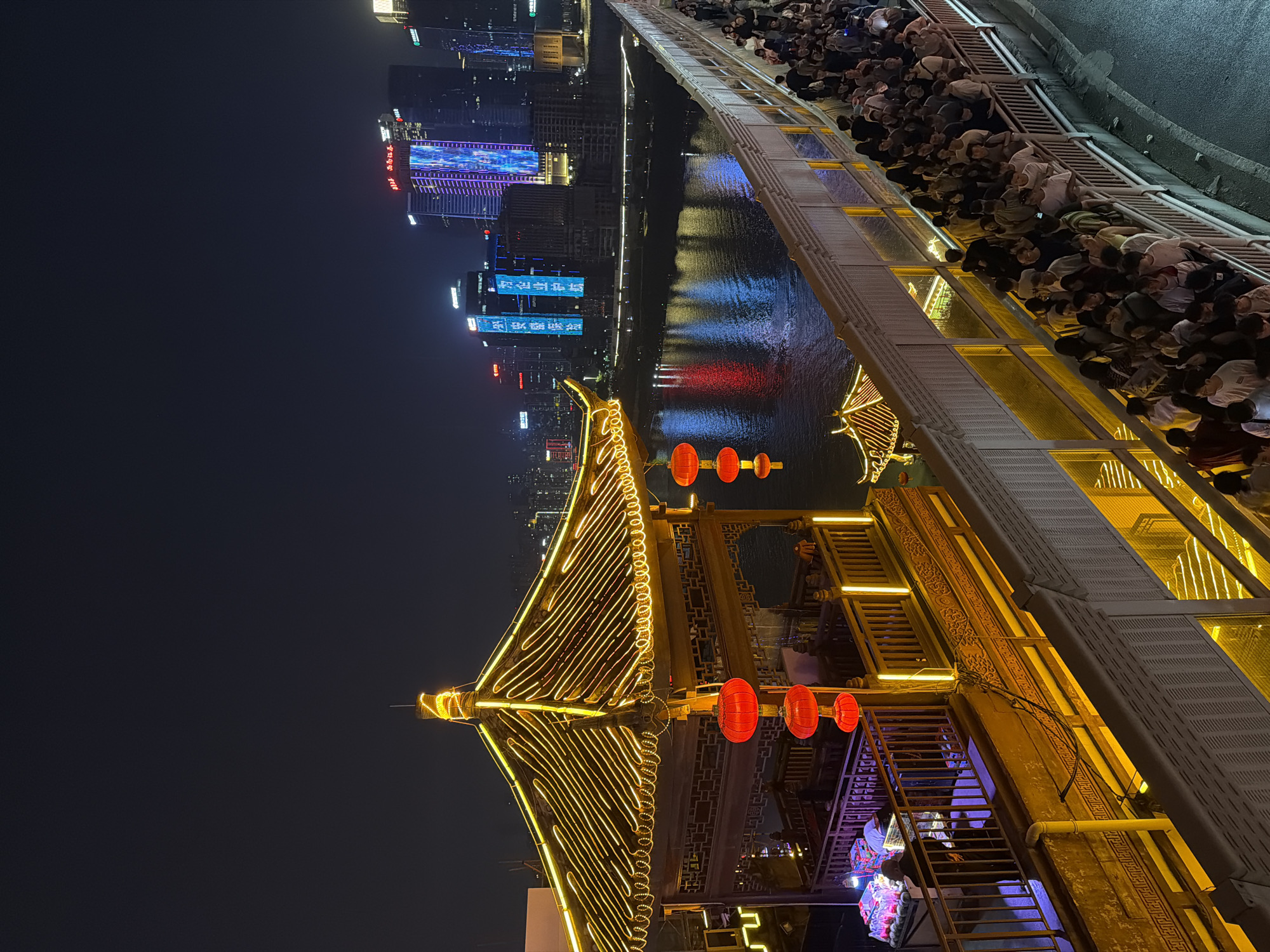 Night cityscape documented along river in Yuzhong District