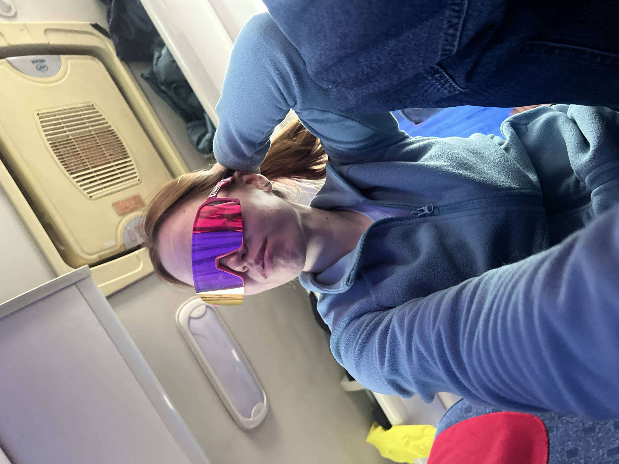 Woman in purple sunglasses observed on flight near Russia