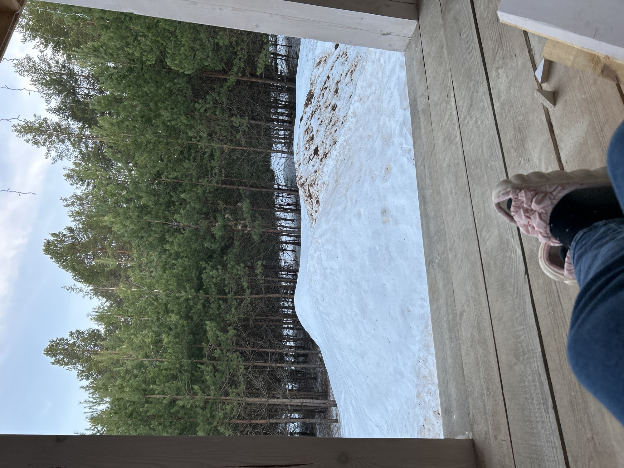 Girl relaxes in hammock on snowy porch in Russia
