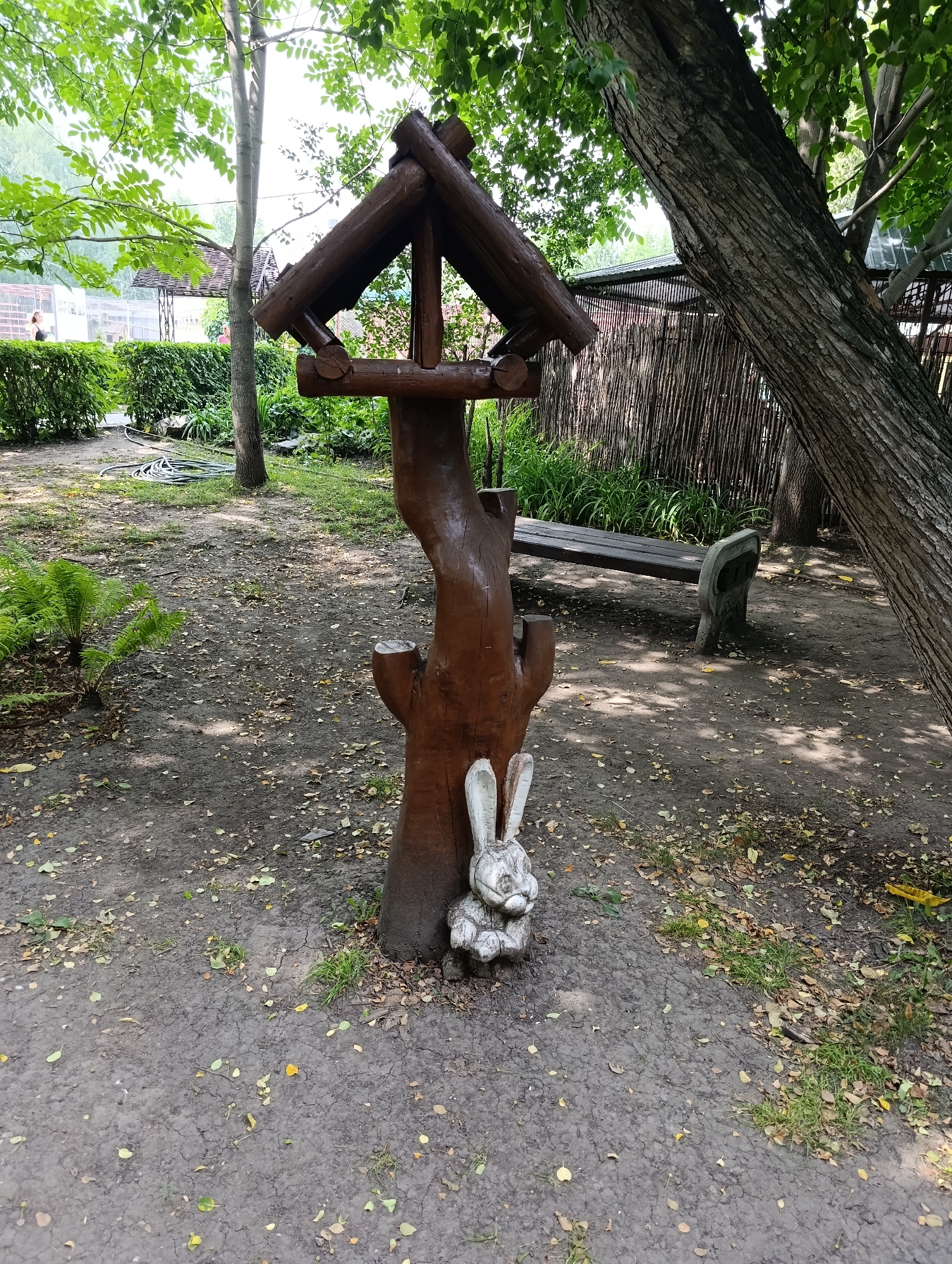 Barnaul park in summer: wooden decor and wildflowers in bloom