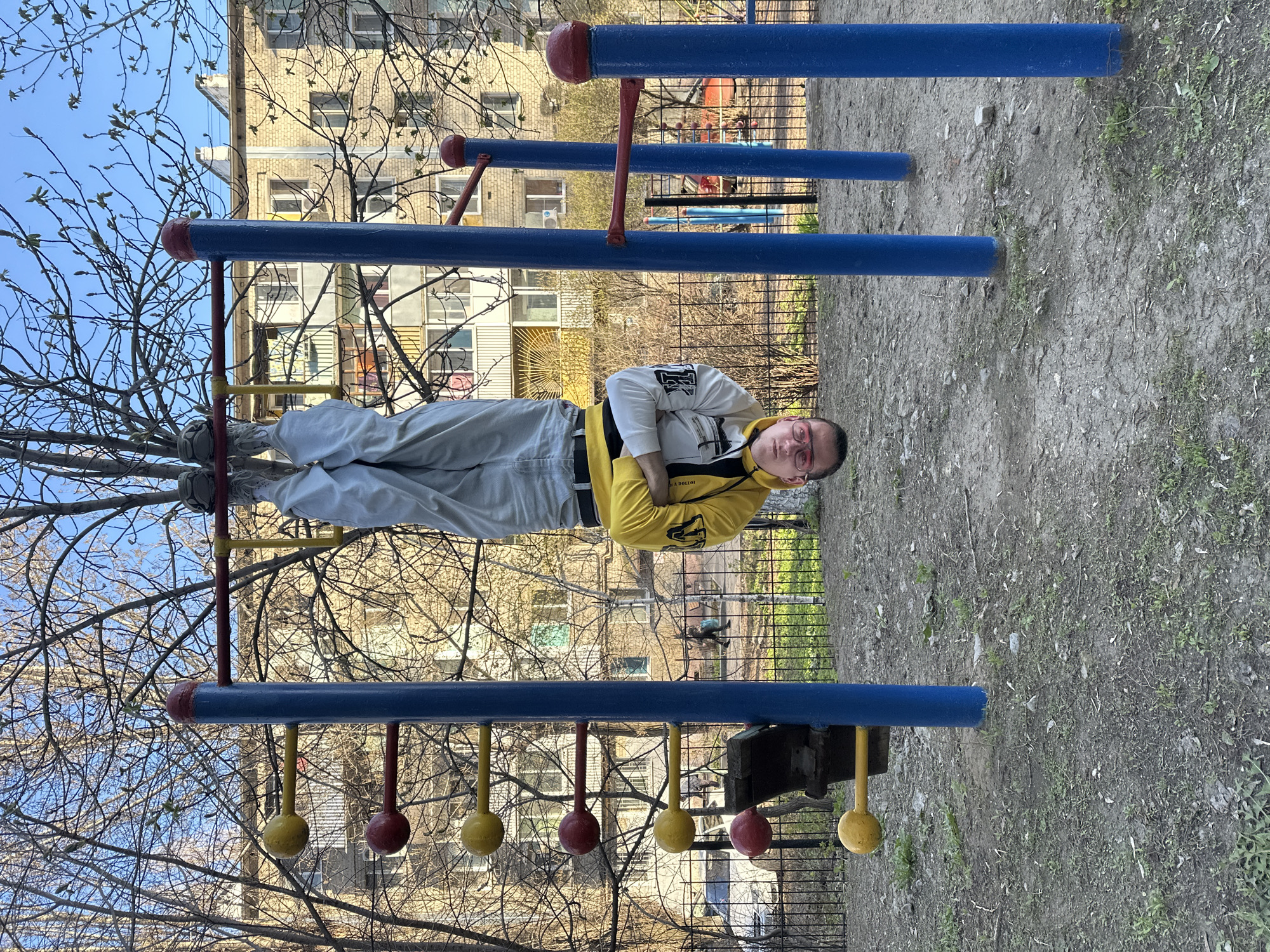 Young man exercises on playground equipment in Saratov