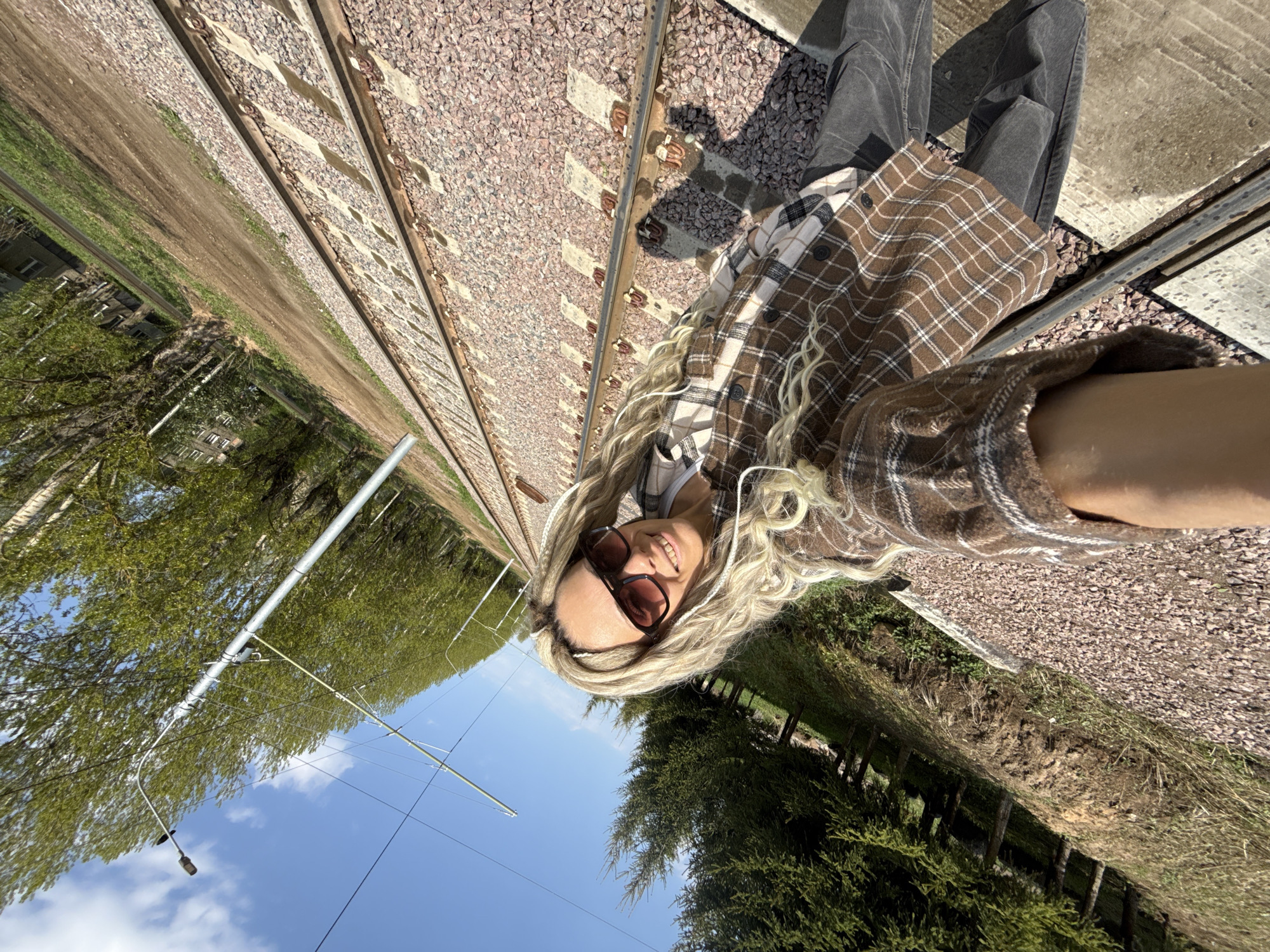 Person photographed near railroad tracks in rural Russia