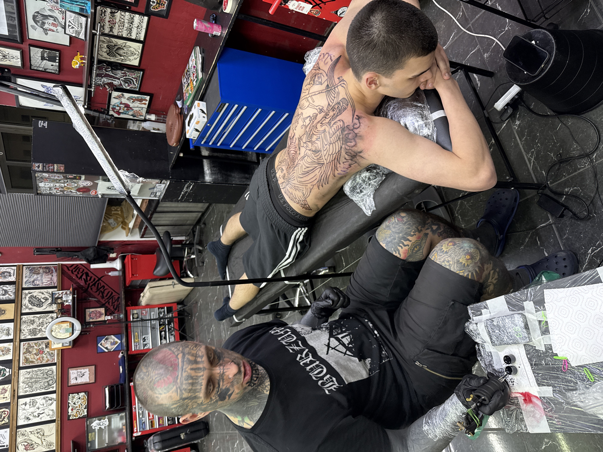 Tattoo artist works on elaborate back piece in Moscow studio