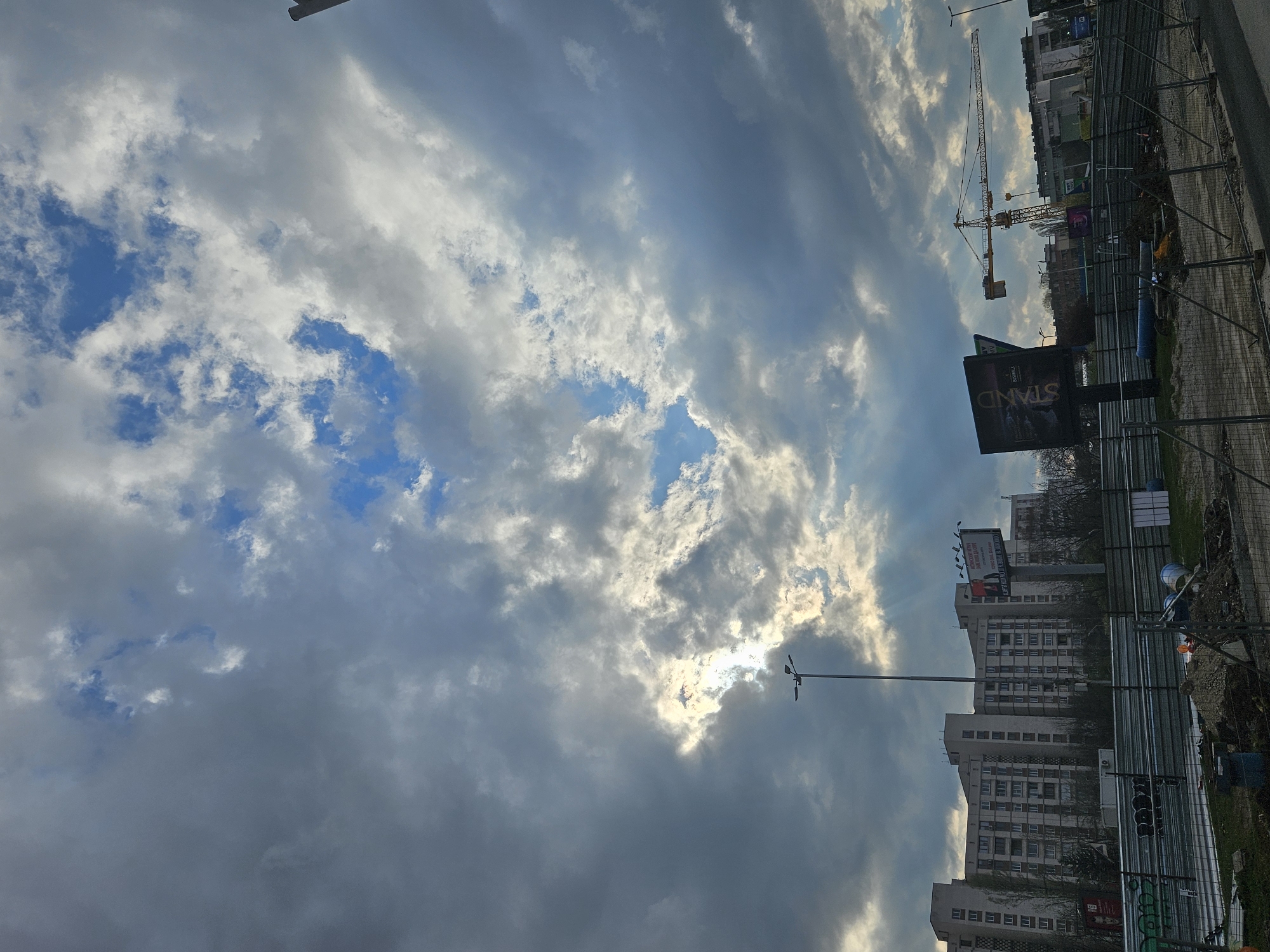 Cloudy afternoon sky observed over Sofia with construction crane visible