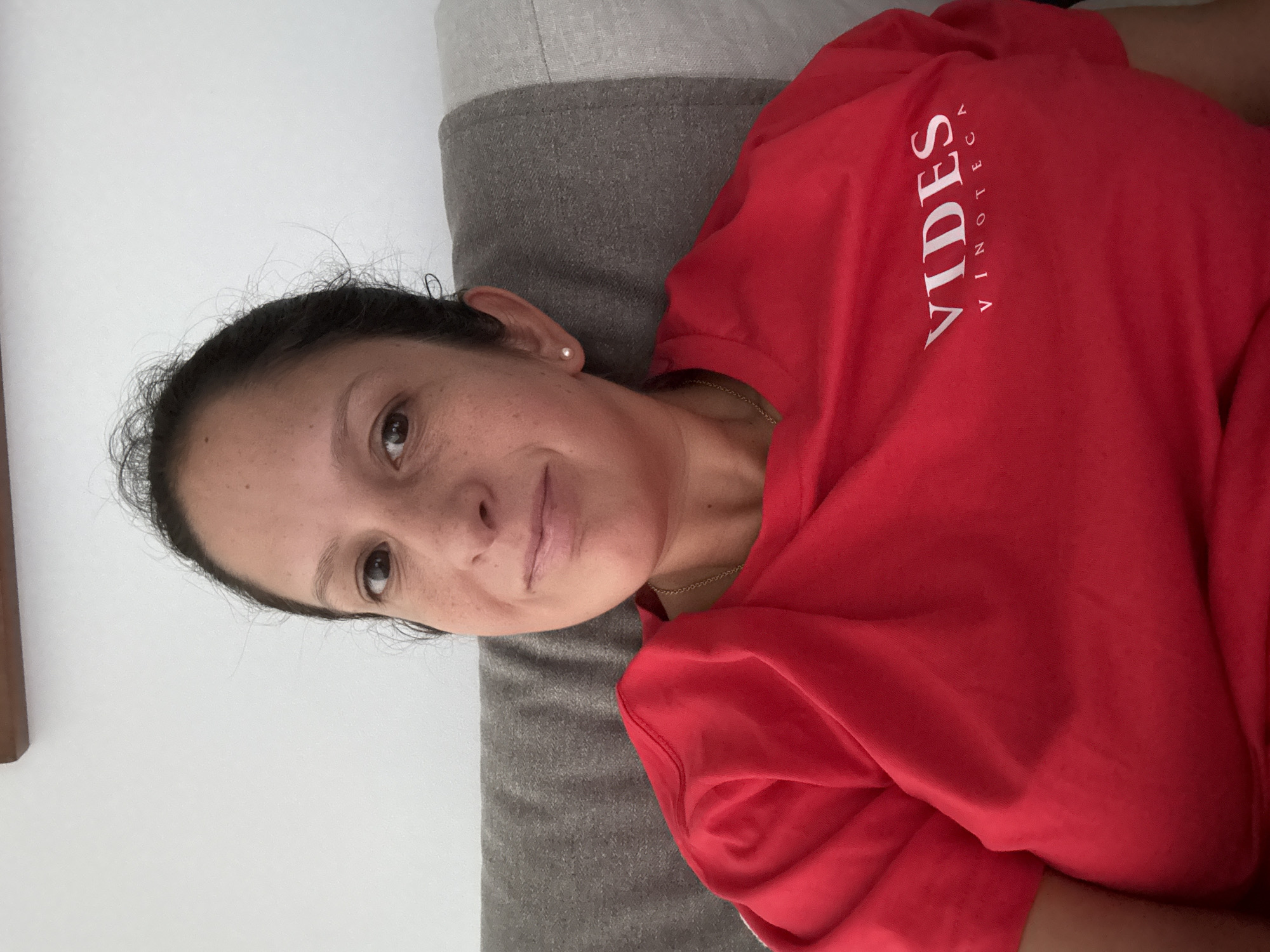 Woman rests on cushion in San Isidro wearing wine bar shirt