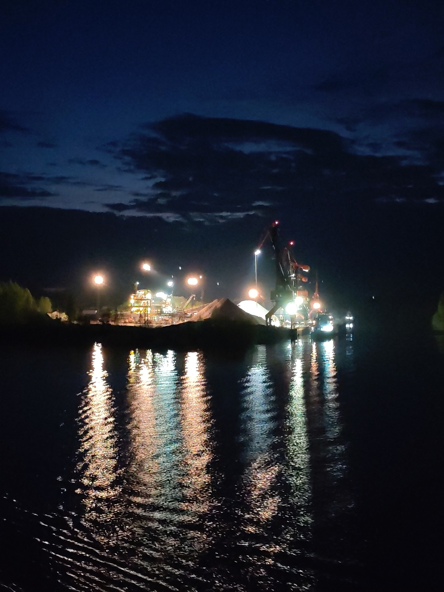 Nighttime industrial activity observed from vessel near Russian waterway