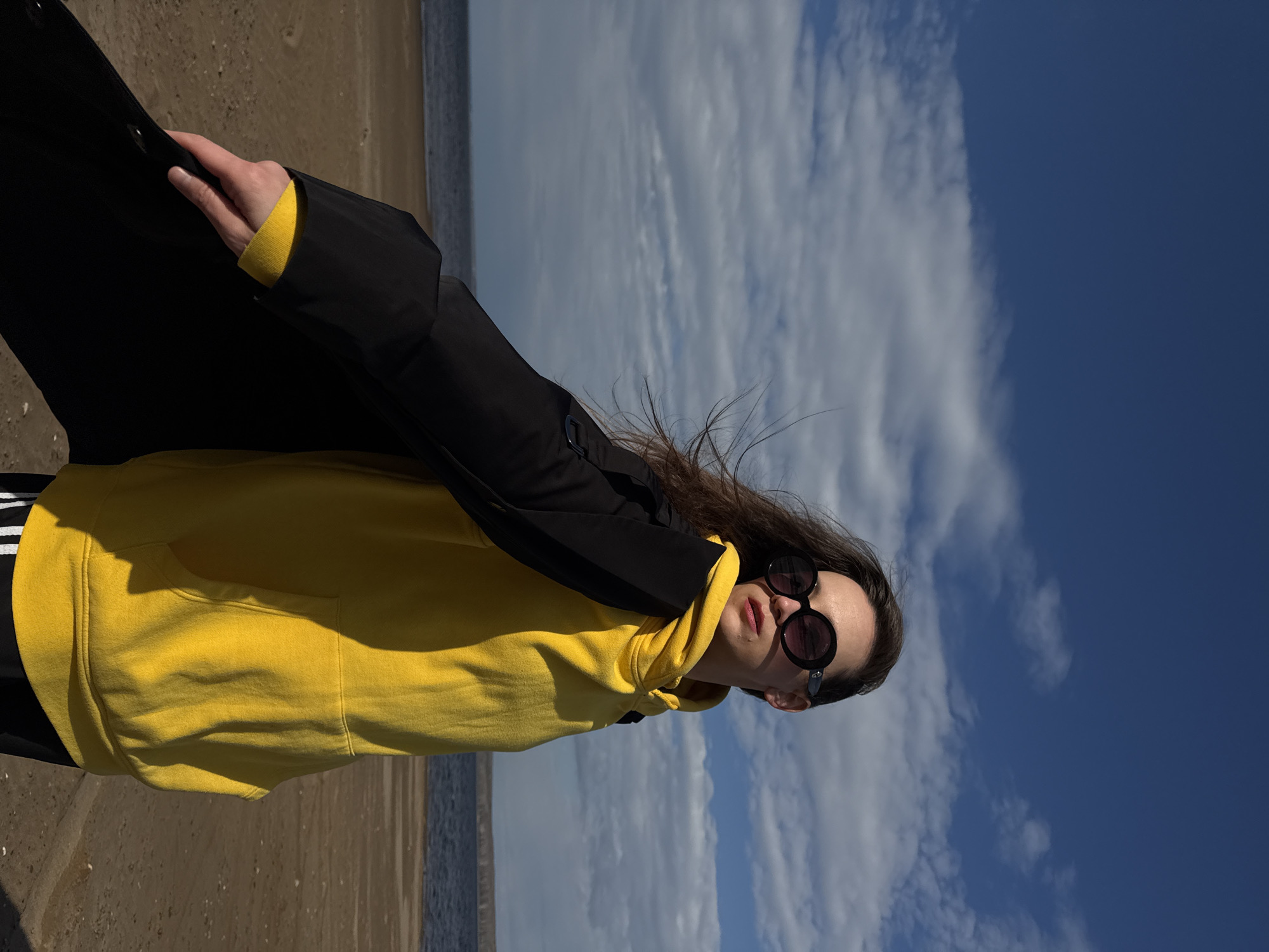 Woman in yellow hoodie enjoys spring day at Russian reservoir