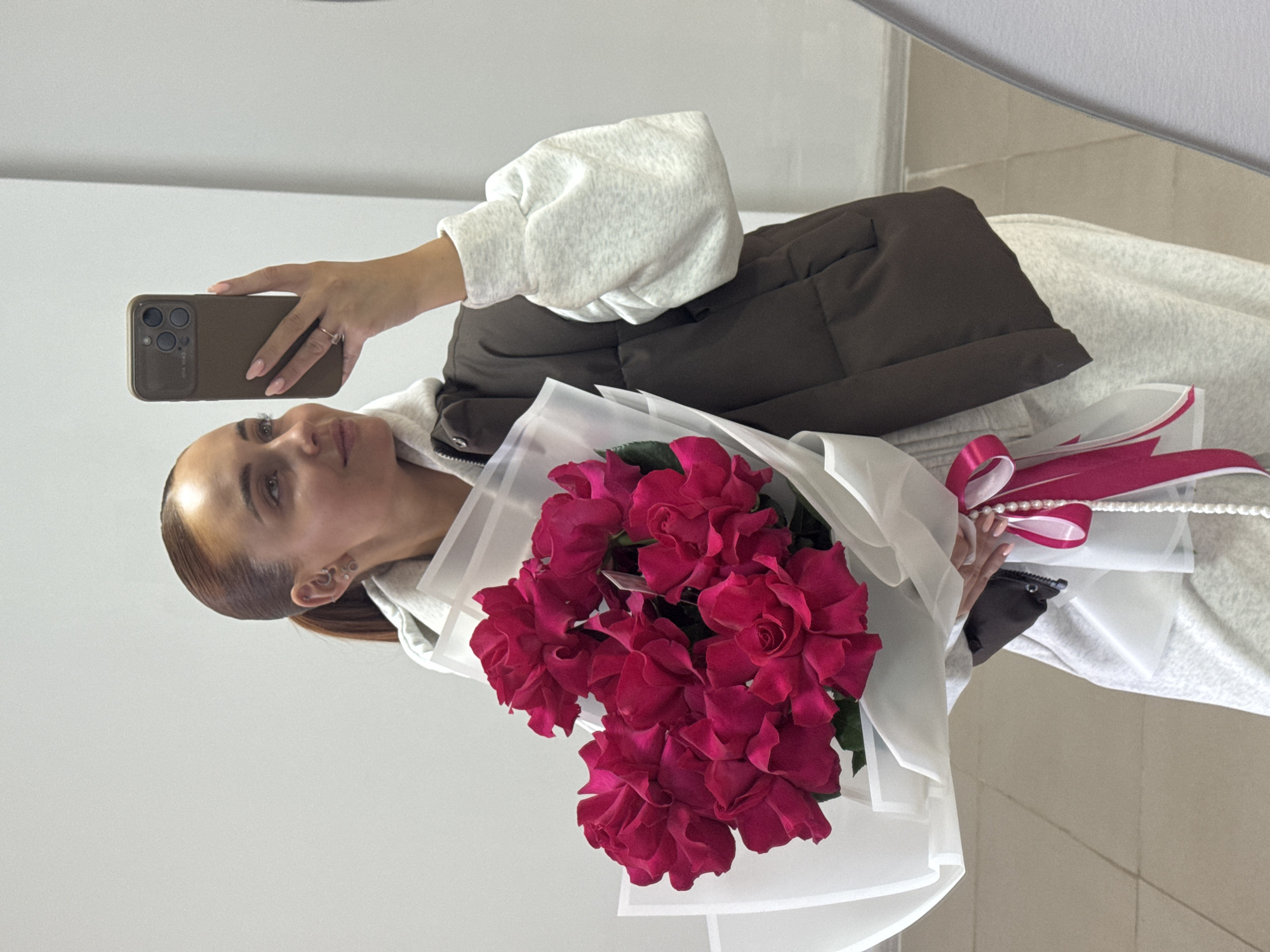Woman takes flower bouquet selfies in Chaikovsky, Russia