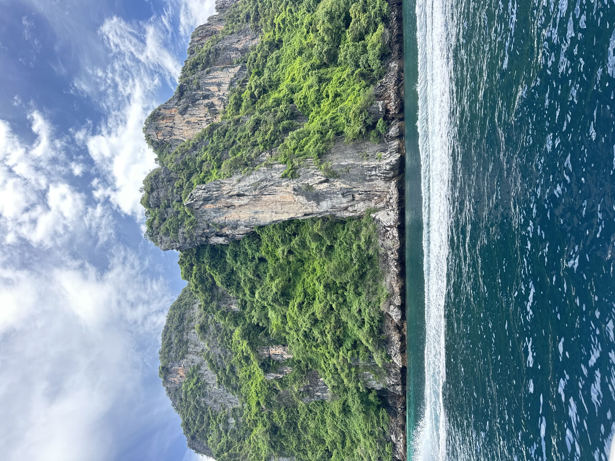 Speedboat crossing Andaman Sea past Ao Nang's karst cliffs