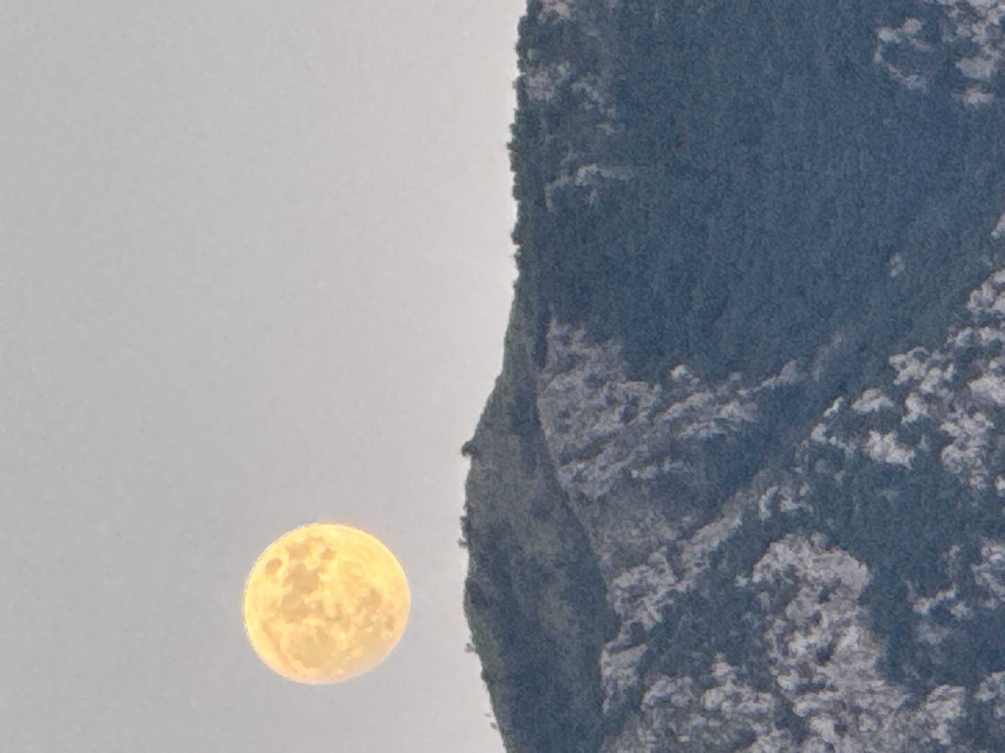 Full moon rising over Montenegro's mountains at dusk