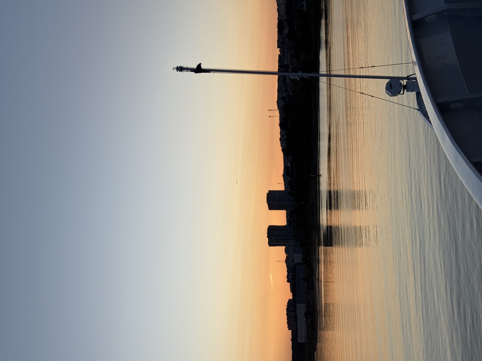 On the water at dusk, passing a cable-stayed bridge near Lapach