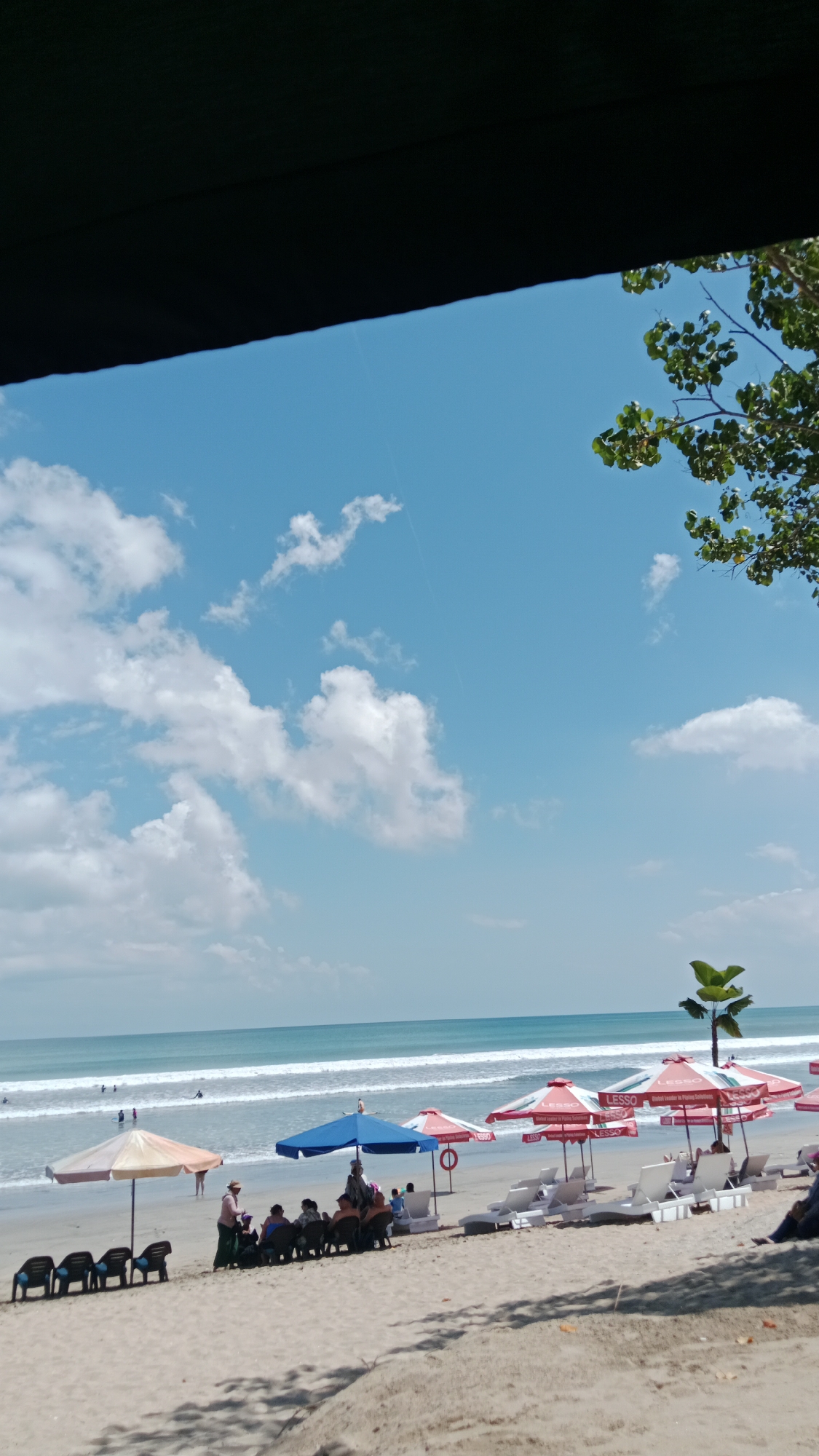 A lively morning scene at Kuta Beach, Bali
