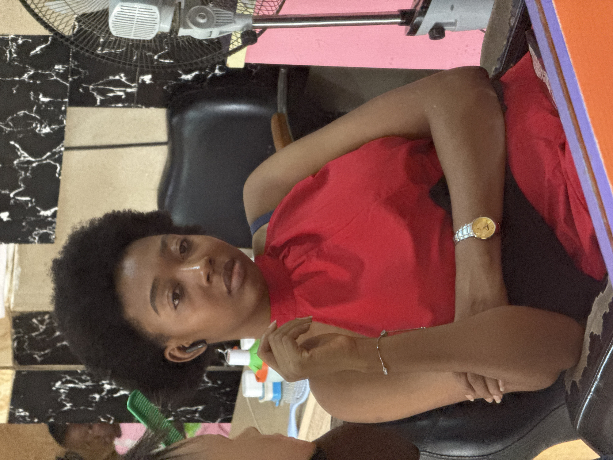 Women receive hair services at Abuja salon Friday afternoon