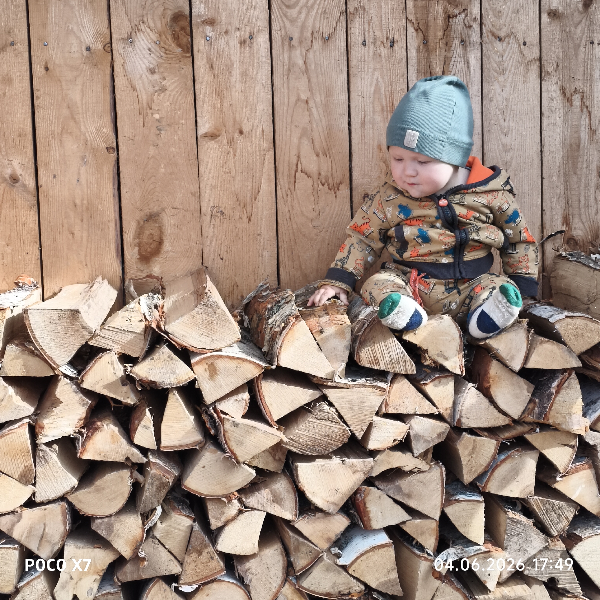 Family moments captured around firewood stacks in Chaikovsky, Russia