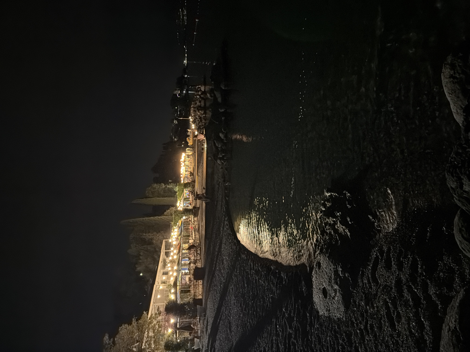 String-lit beachside restaurant on Lake Garda at night