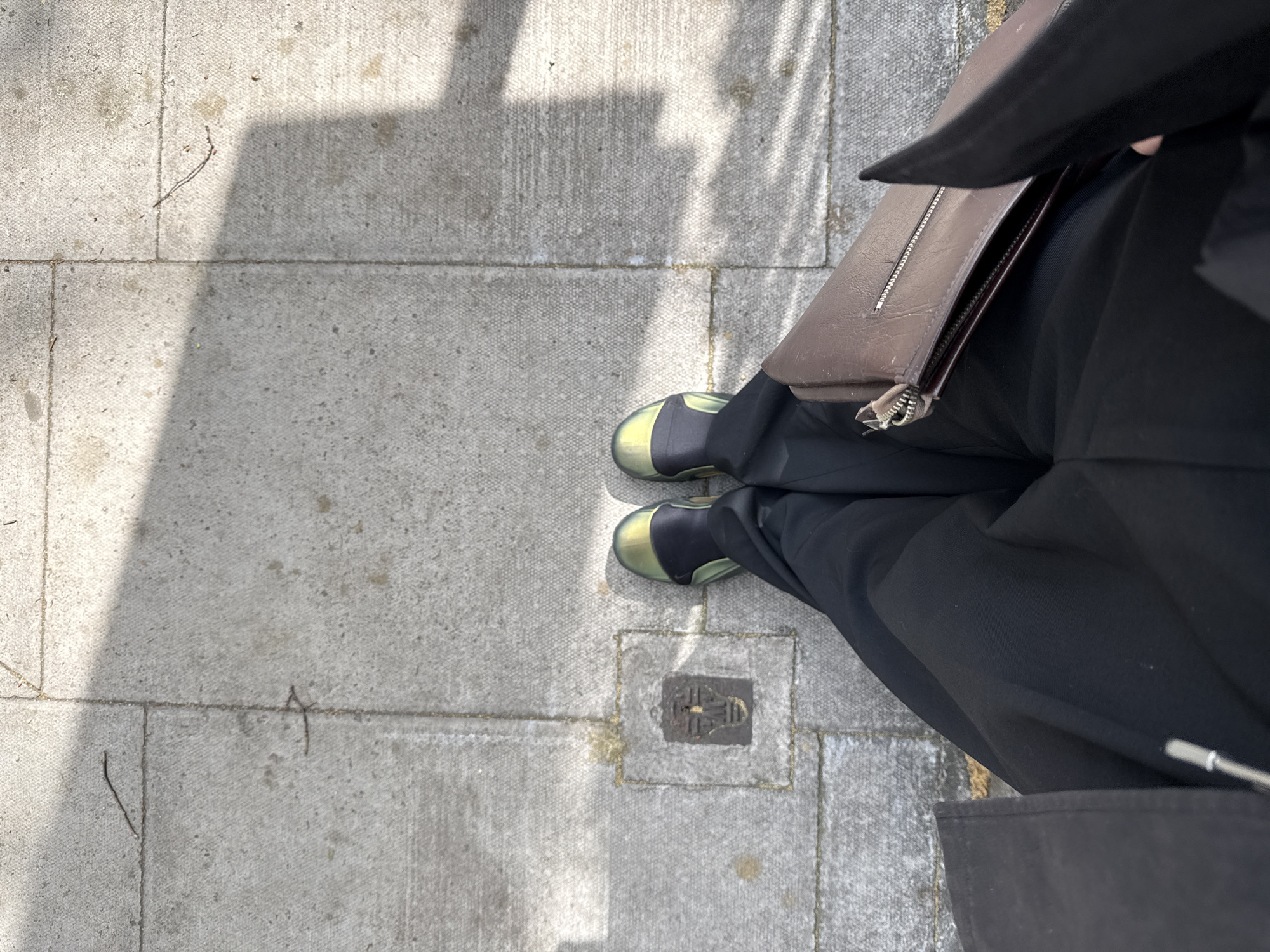 Person stands on London sidewalk Tuesday morning