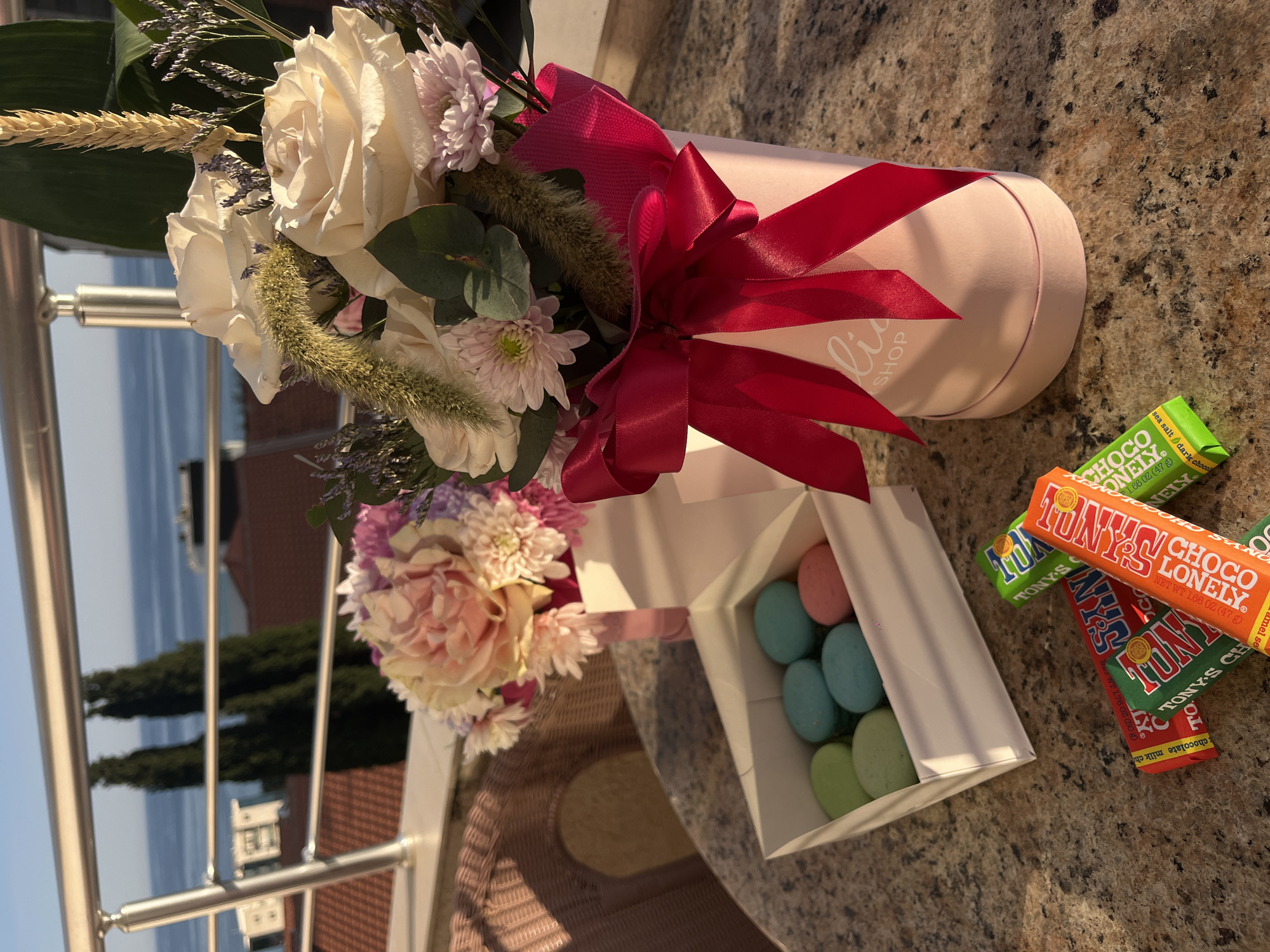 Celebration setup with flowers, macarons captured on Montenegro coast
