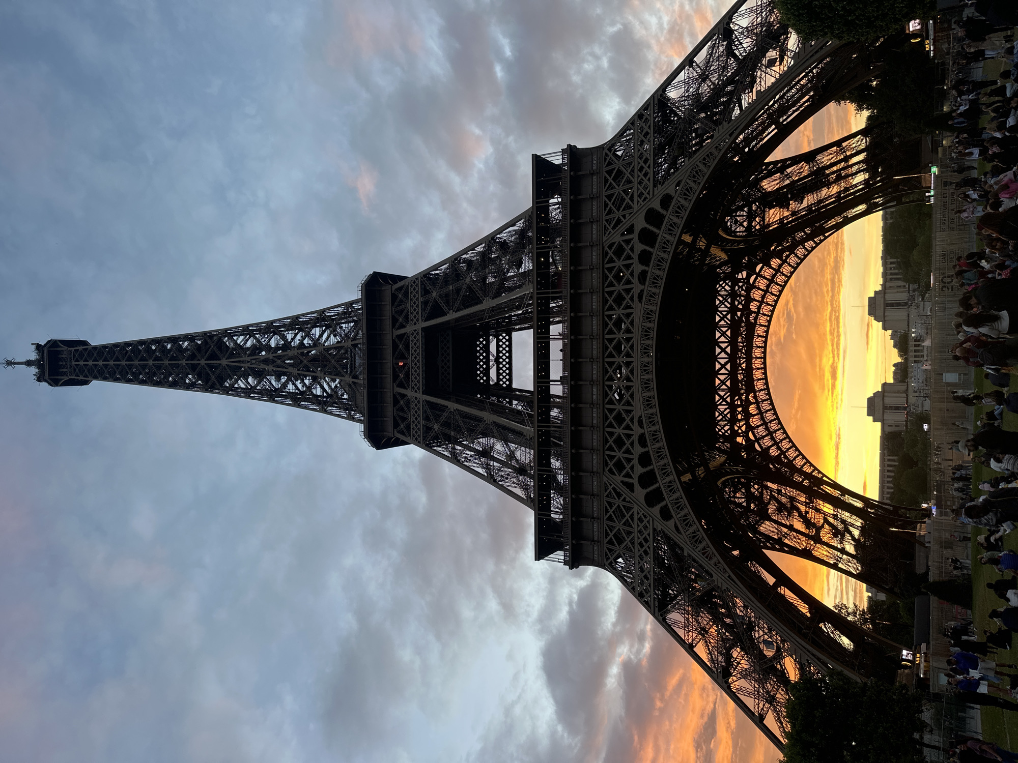 Crowds gather at Eiffel Tower for dramatic sunset viewing