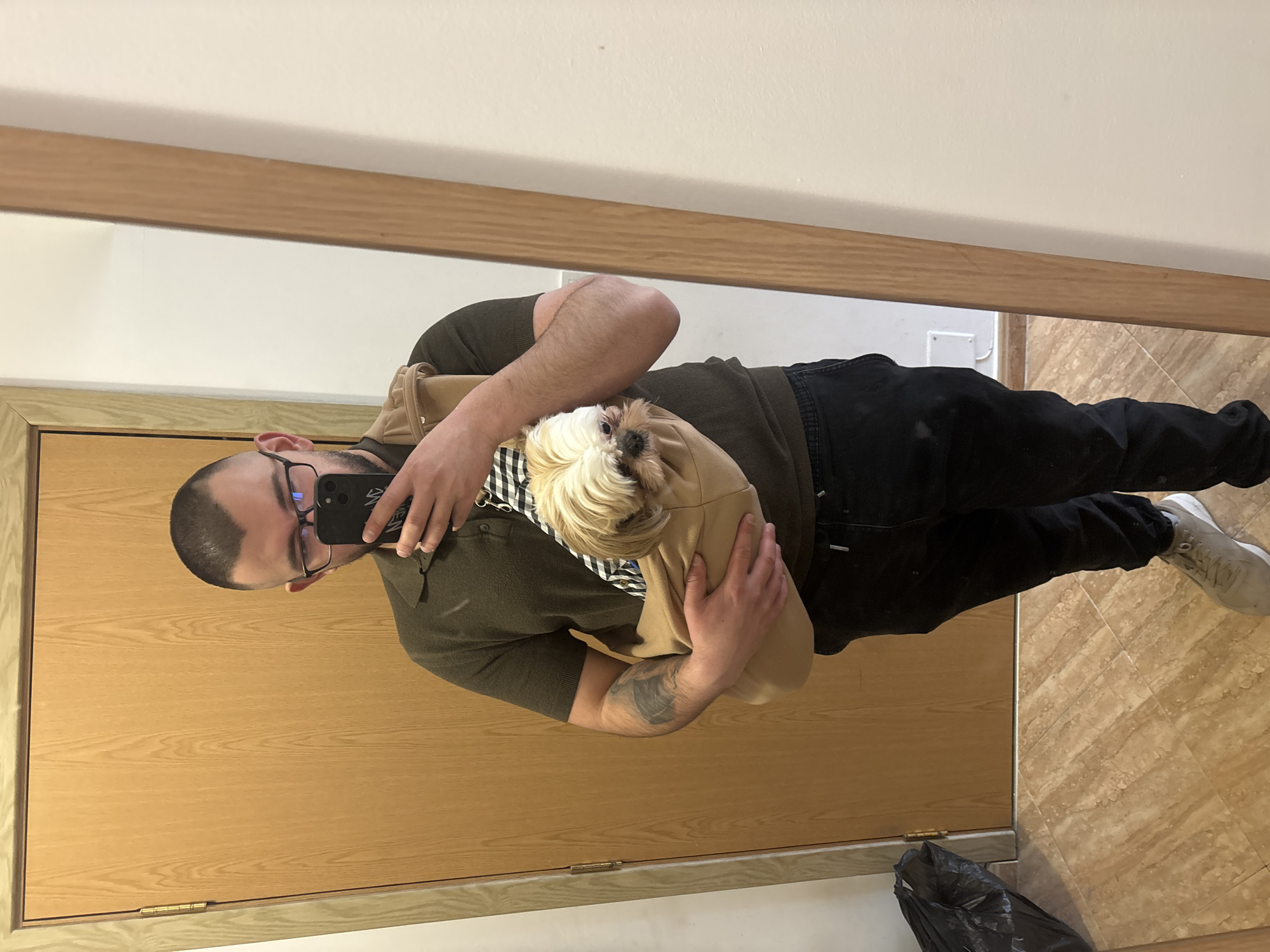 Man takes mirror selfies with small dog in Sofia