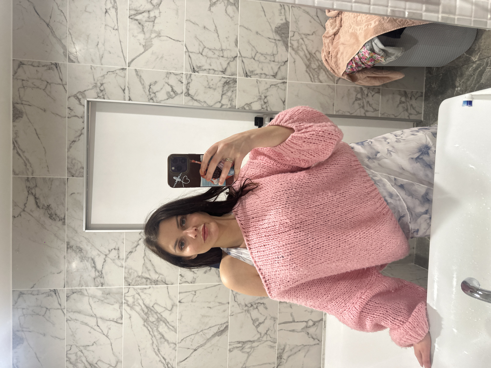 Mirror selfie highlighting a layered off-shoulder sweater look.