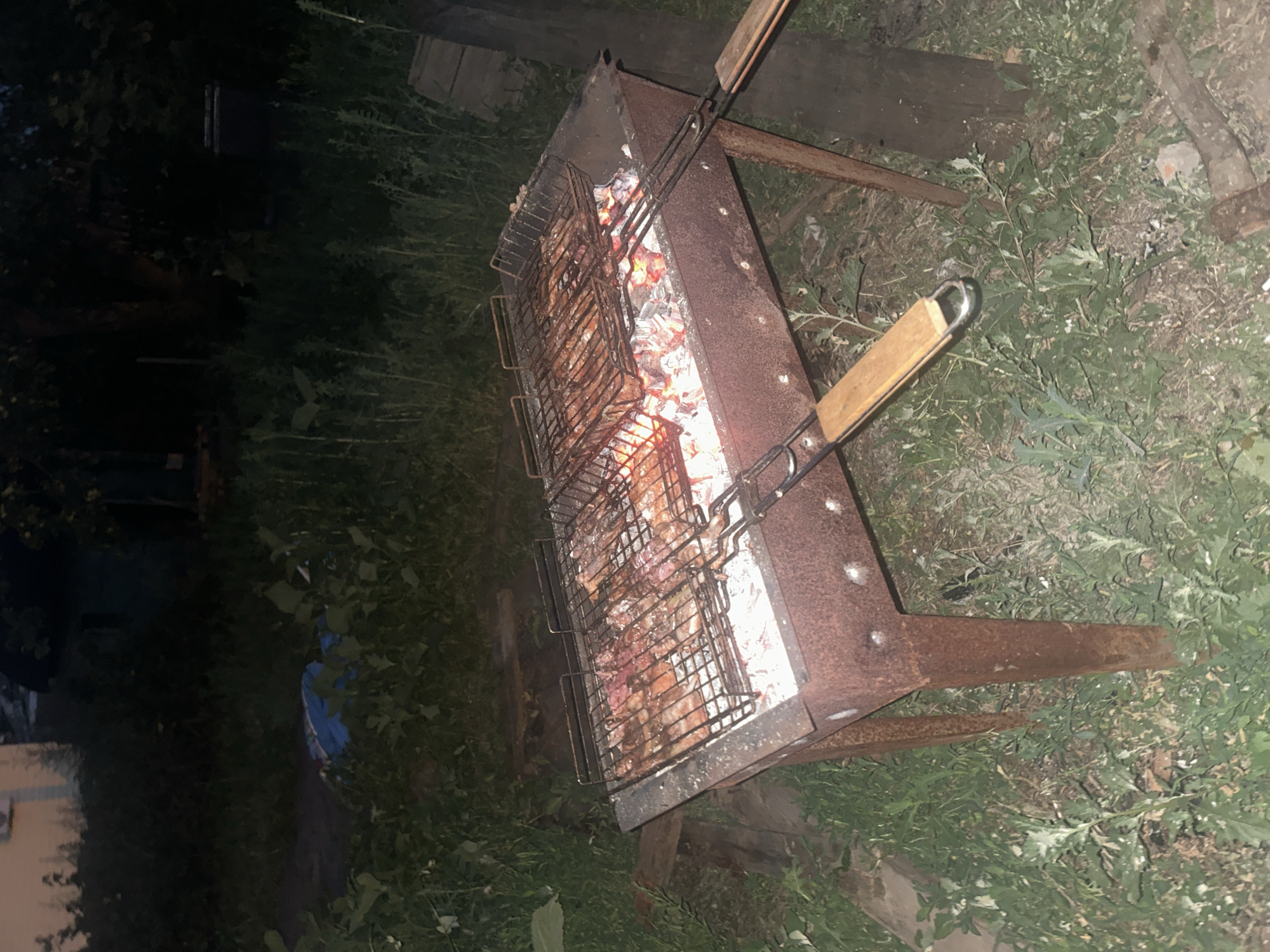 Backyard grill session at dusk in Engels, Russia