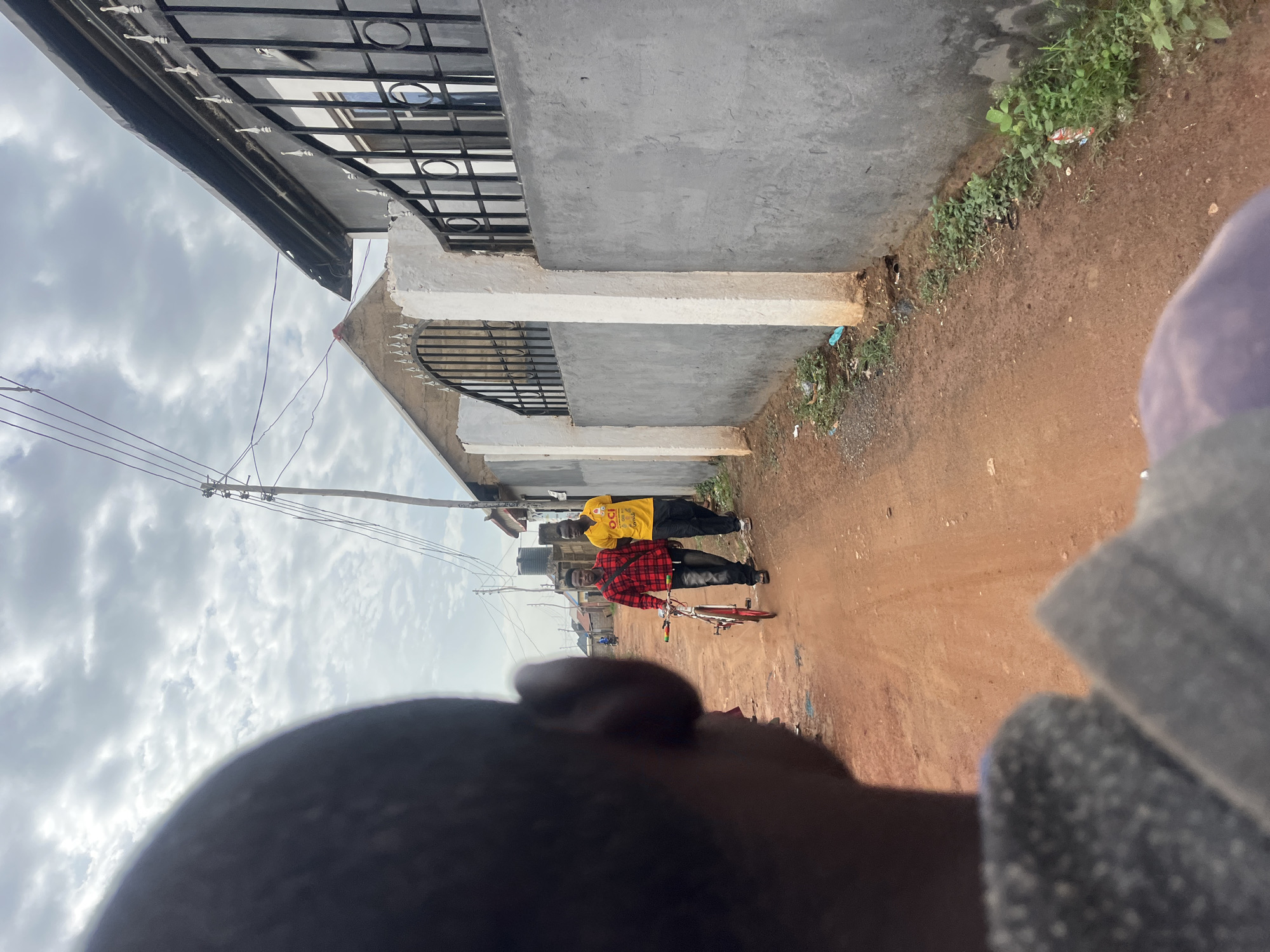 Morning street documentation captures Abuja residential scenes, waste areas
