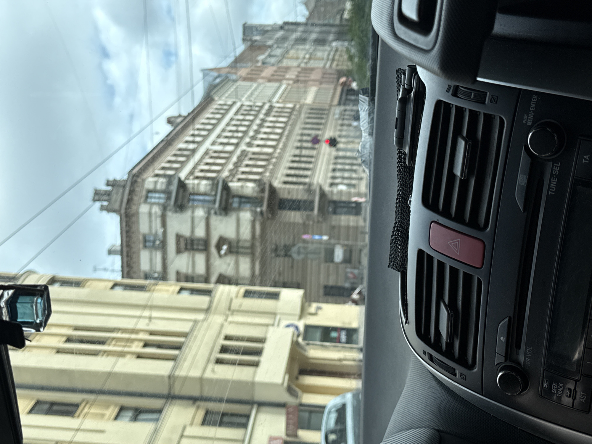 Dashboard-framed view of Riga streets through a car windshield