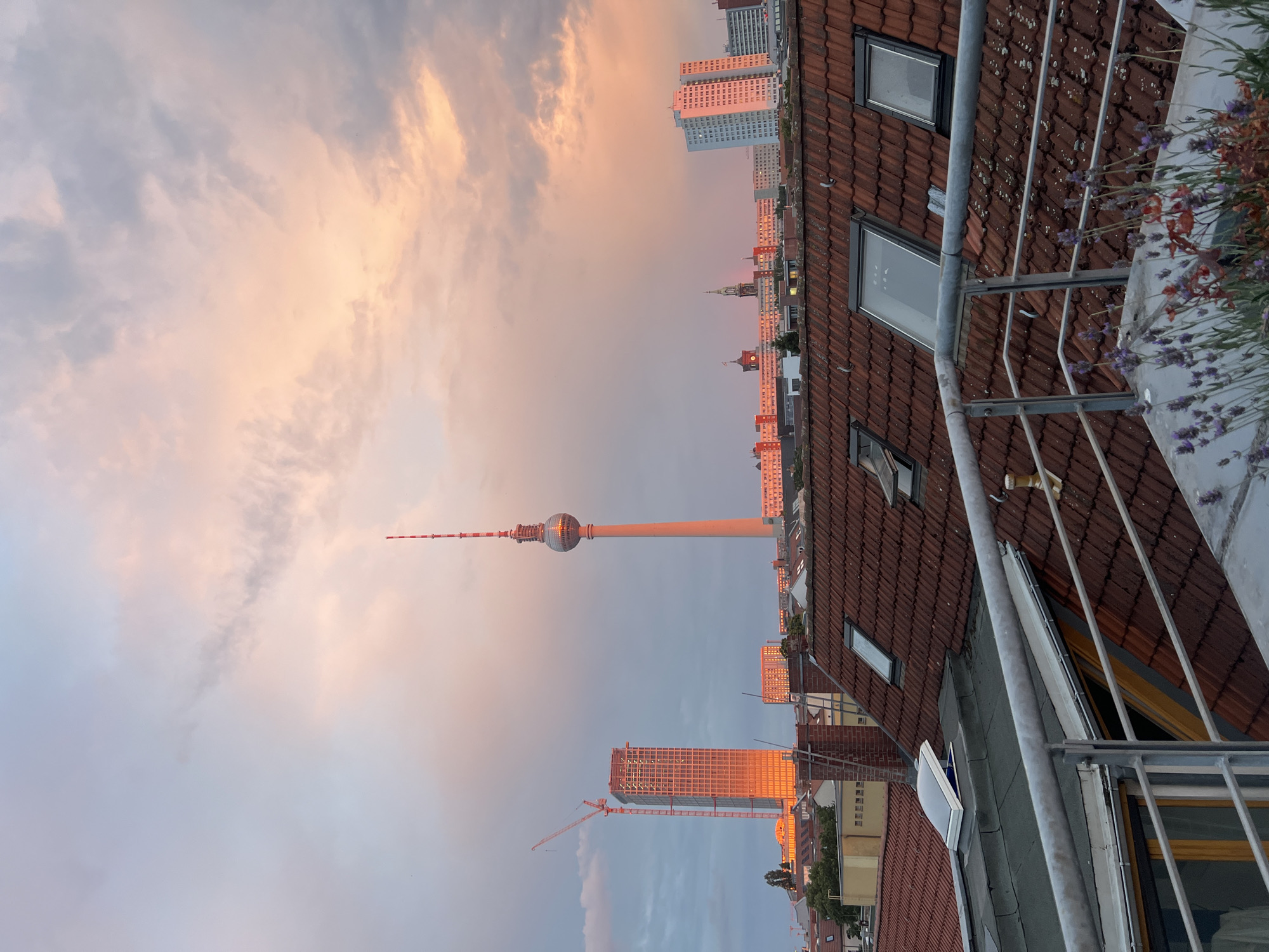 Berlin rooftop at golden hour with food prep underway